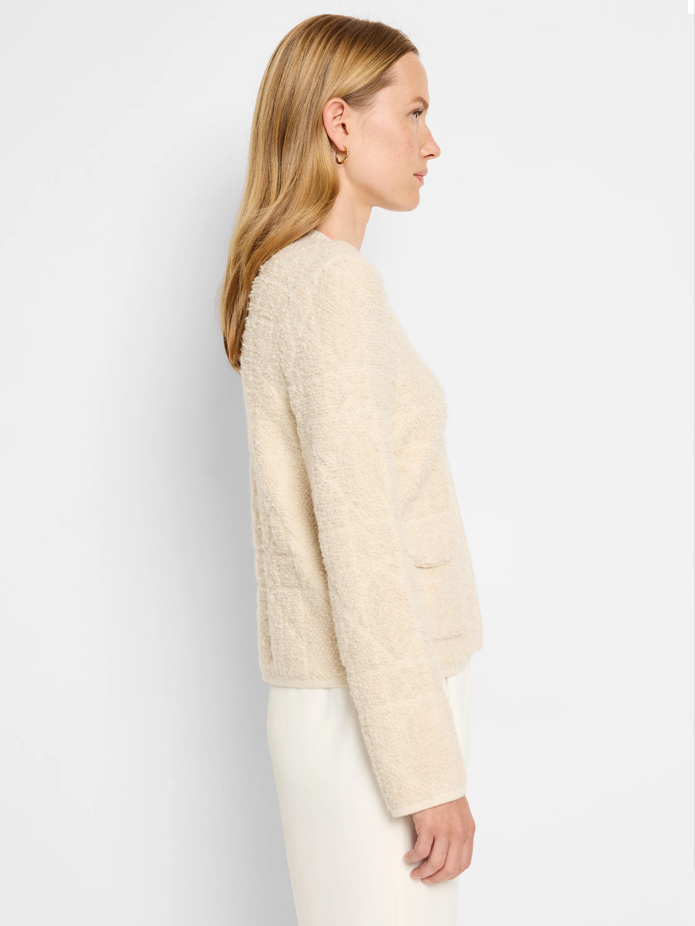 Off-white sherpa jacket, long sleeves, small patch pocket. Textured fabric.