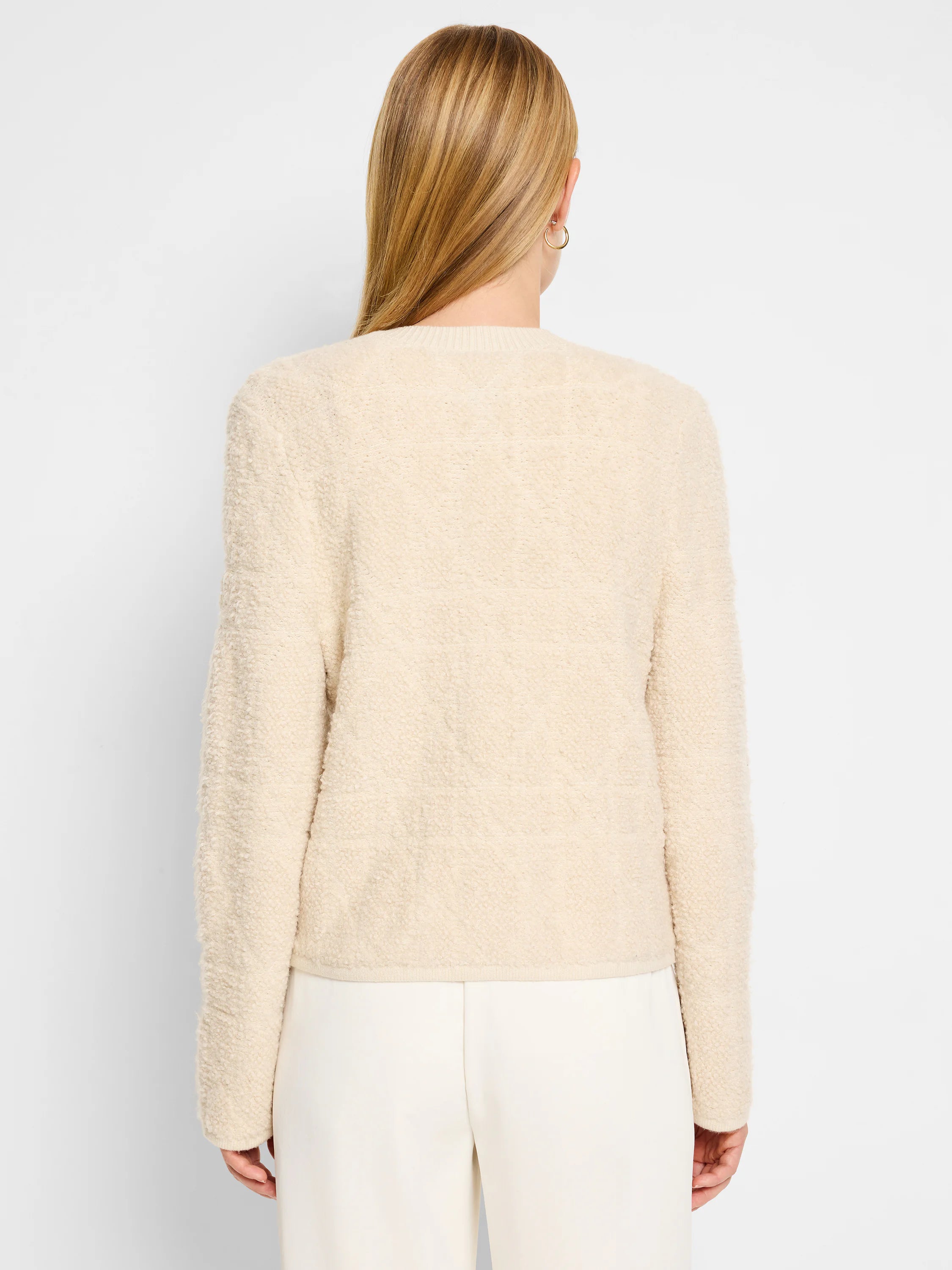 Cream-colored sherpa jacket, long sleeves, cropped length. Rear view.