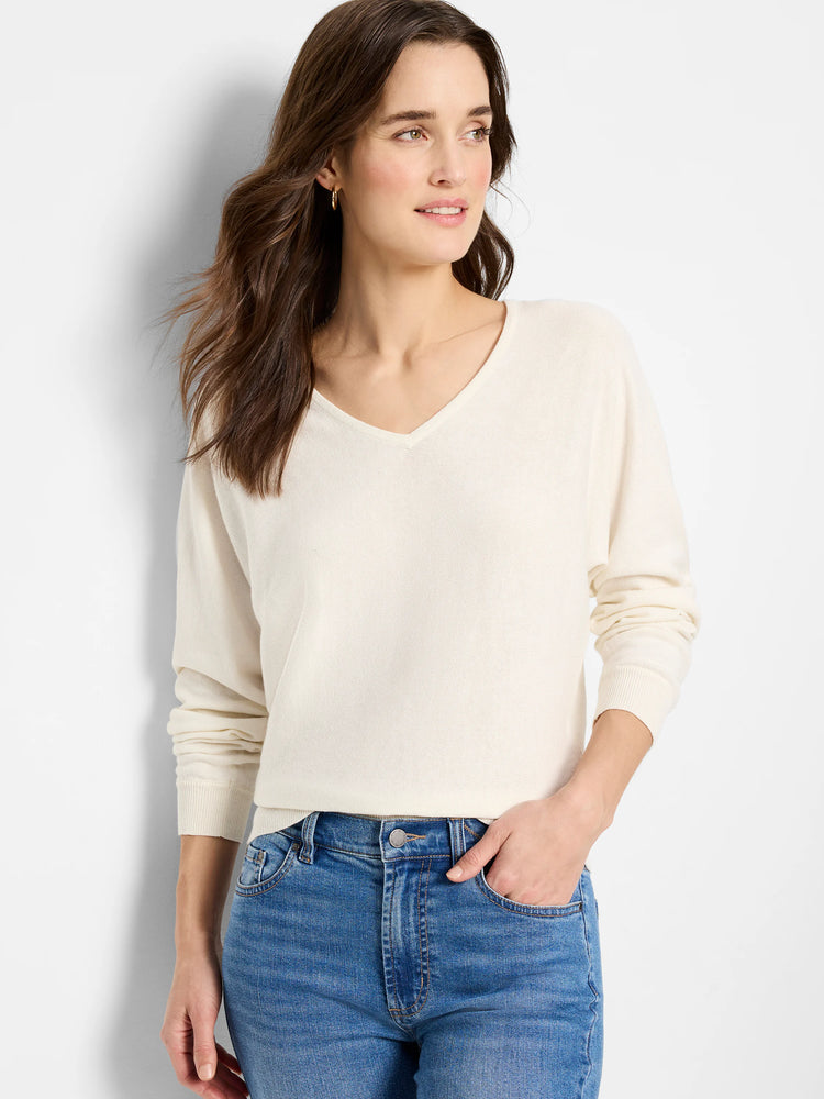 Off-white dolman-sleeve sweater, V-neck. Long sleeves, boxy fit.