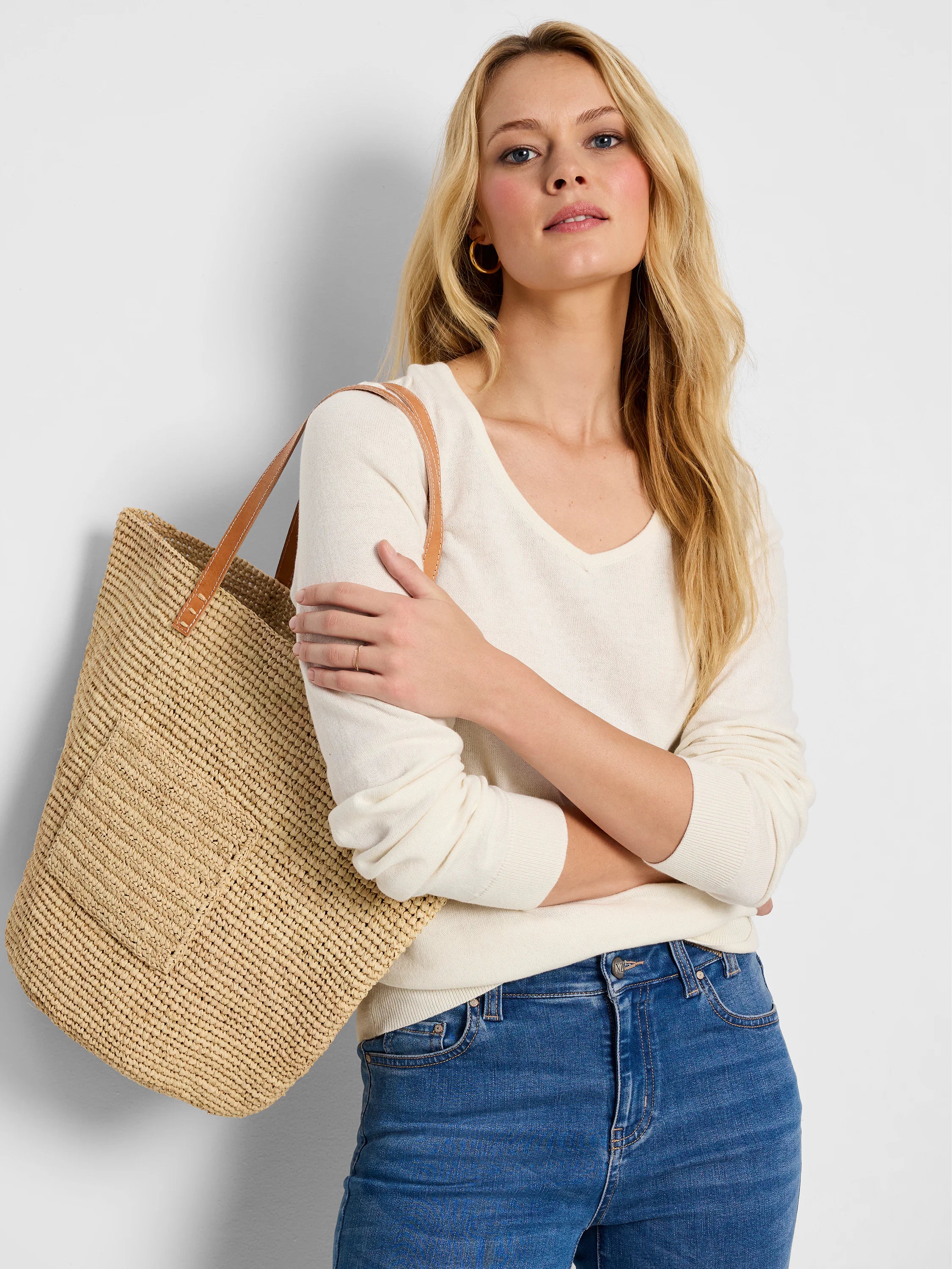 Off-white, long-sleeved v-neck sweater.