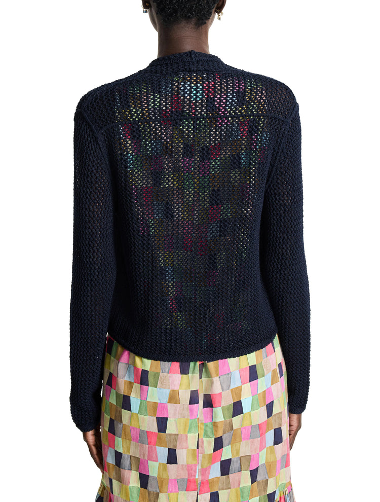 Dark navy blue mesh cardigan, open back revealing multicolored pattern. Long sleeves.