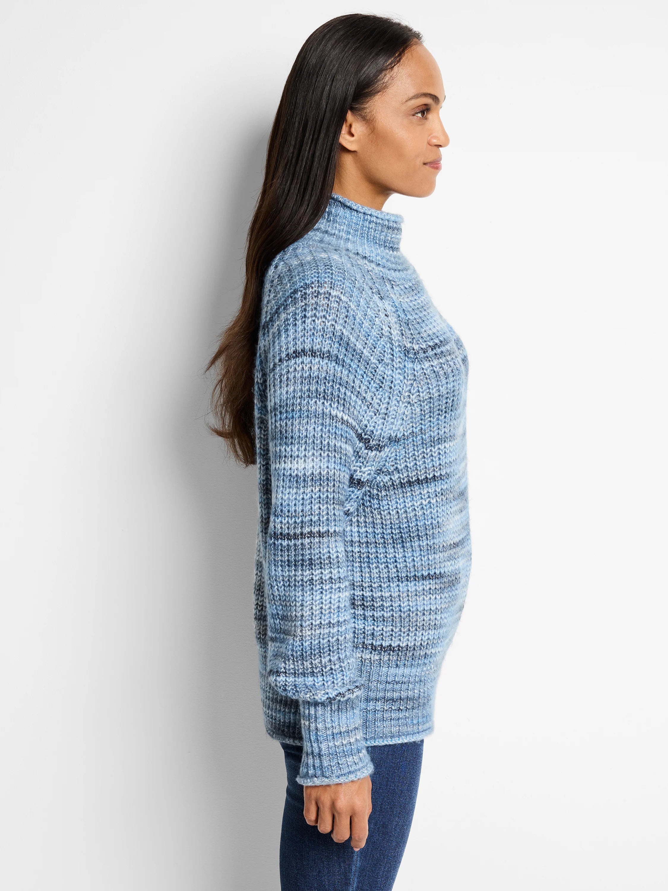 Light blue knit sweater with subtle darker blue and white stripes. High neck, long sleeves, and a relaxed fit.