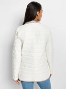 White quilted puffer jacket, reversed to show light taupe lining at collar, cuffs, and hem.