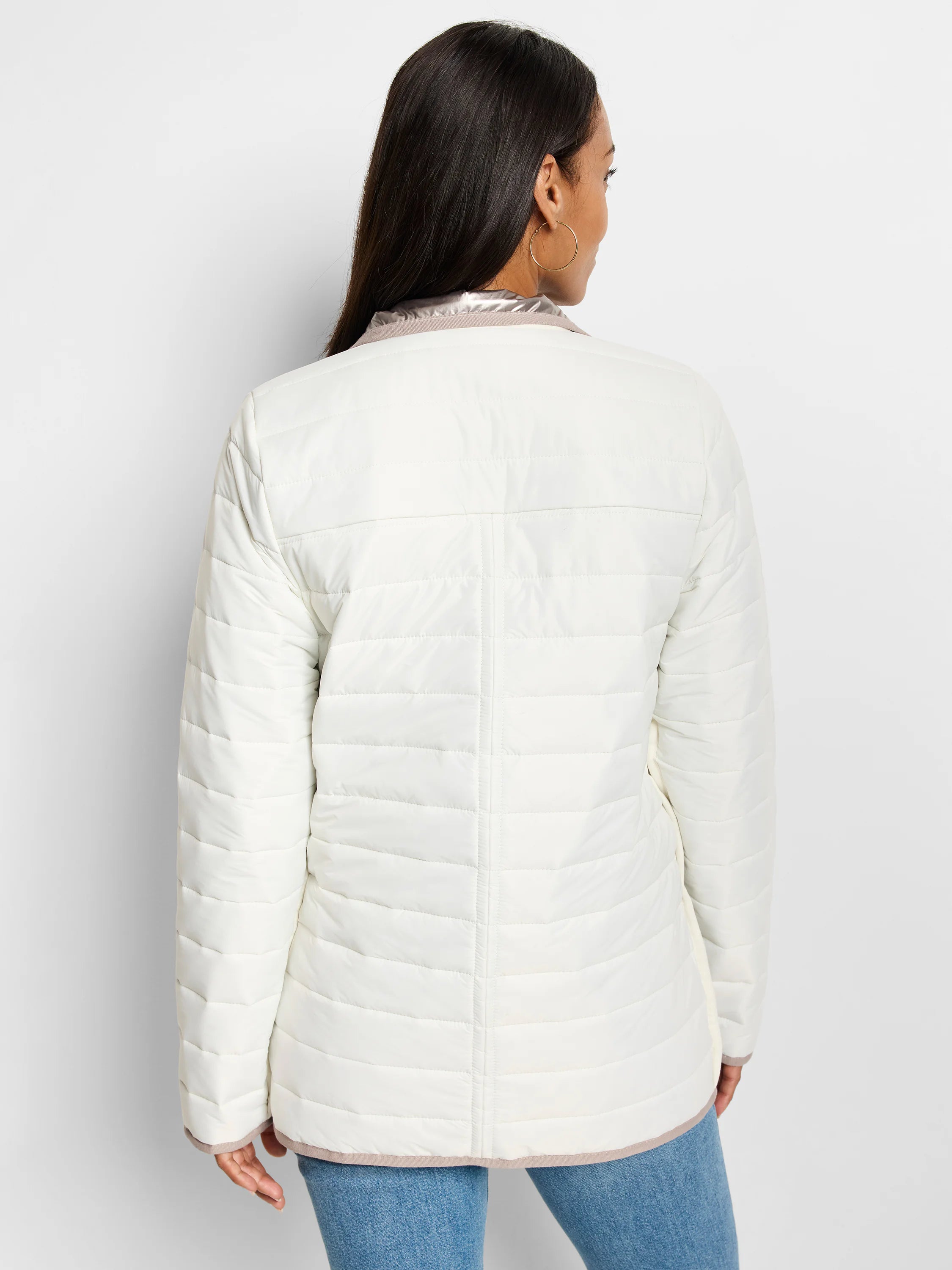 White quilted puffer jacket, reversed to show light taupe lining at collar, cuffs, and hem.