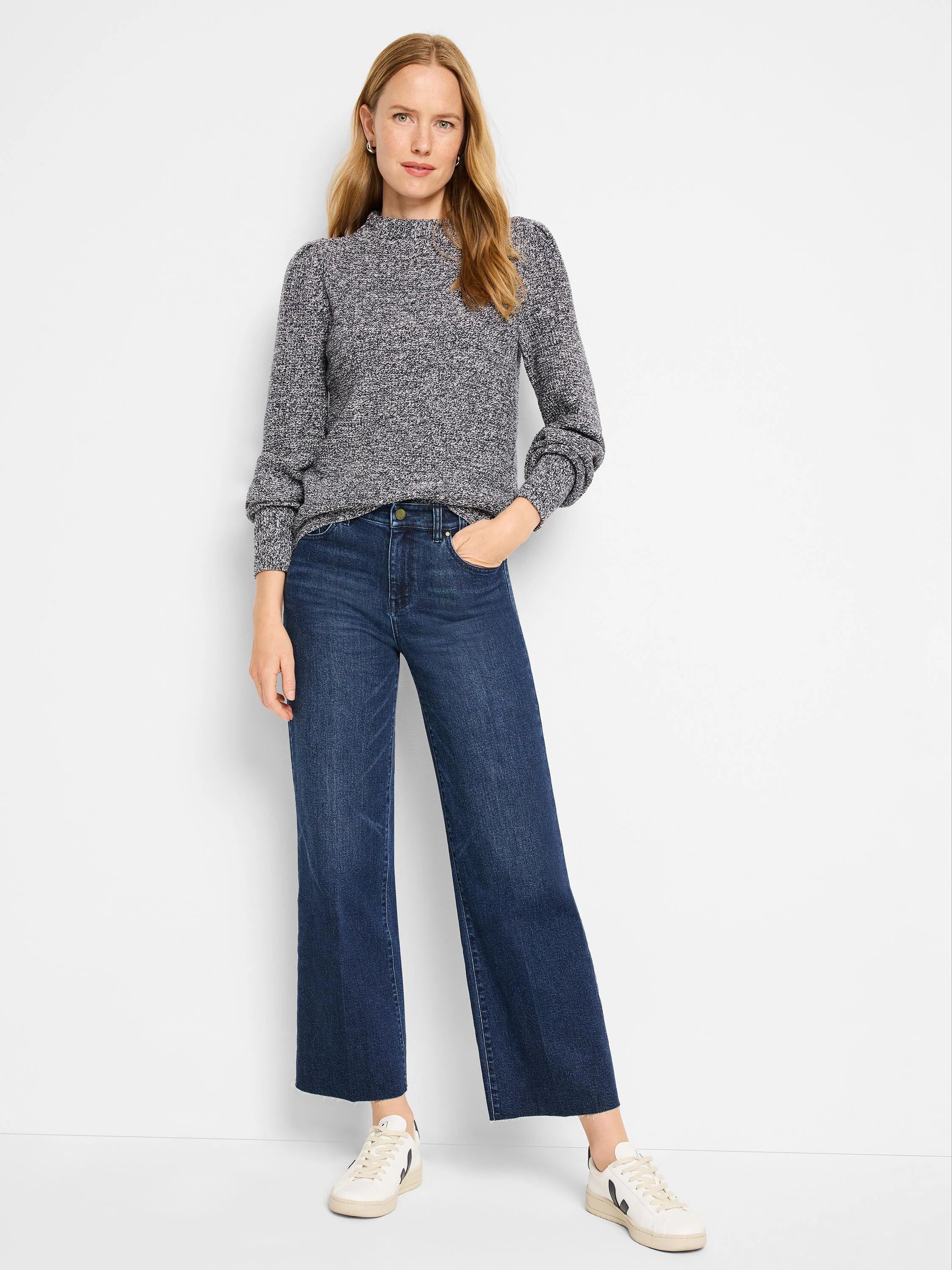 Marled grey waffle stitch sweater with a mock neck, puffed shoulders, and ribbed cuffs.