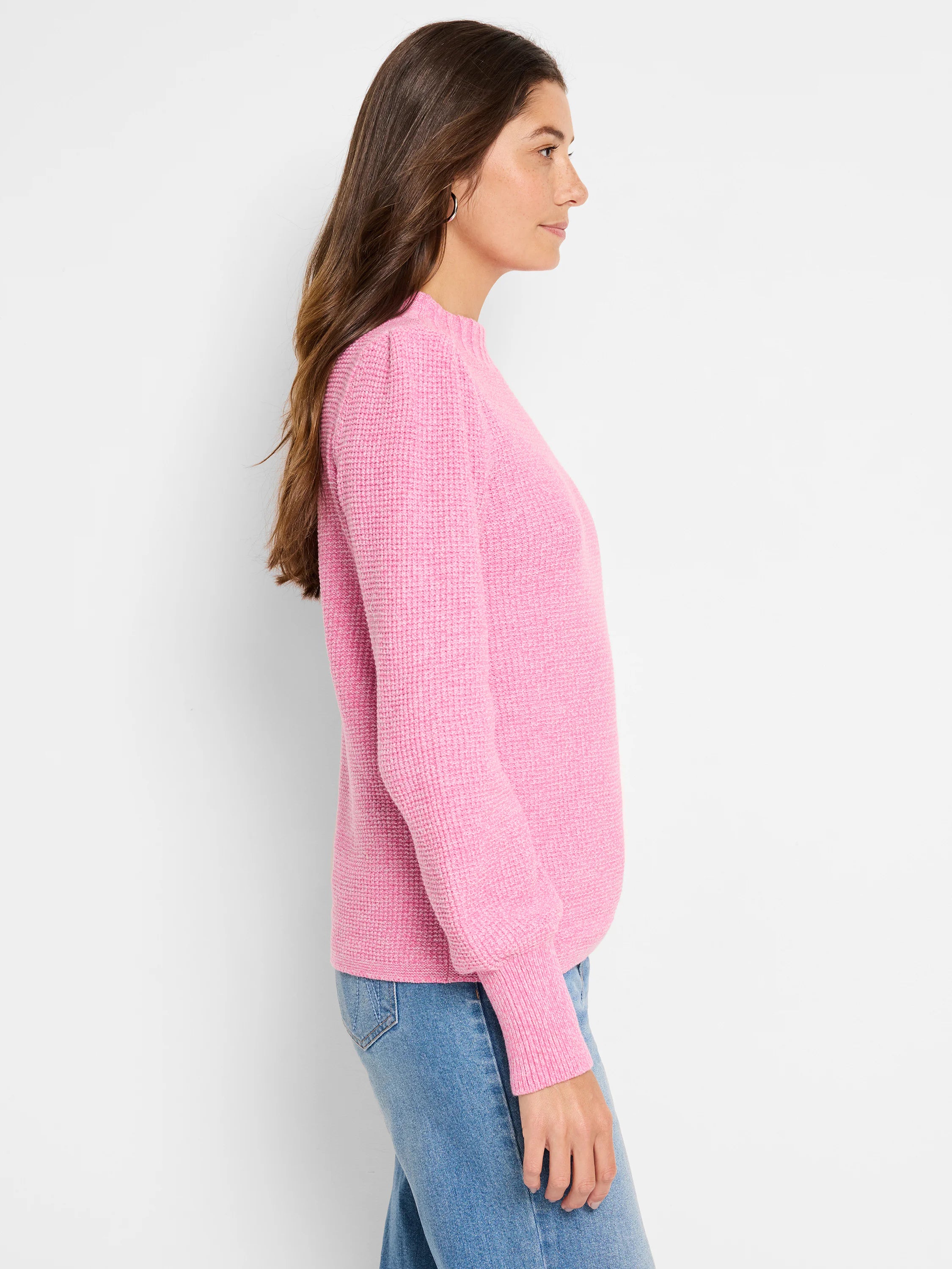 Pink waffle stitch sweater with a mock neck, puffed shoulders, and ribbed cuffs.