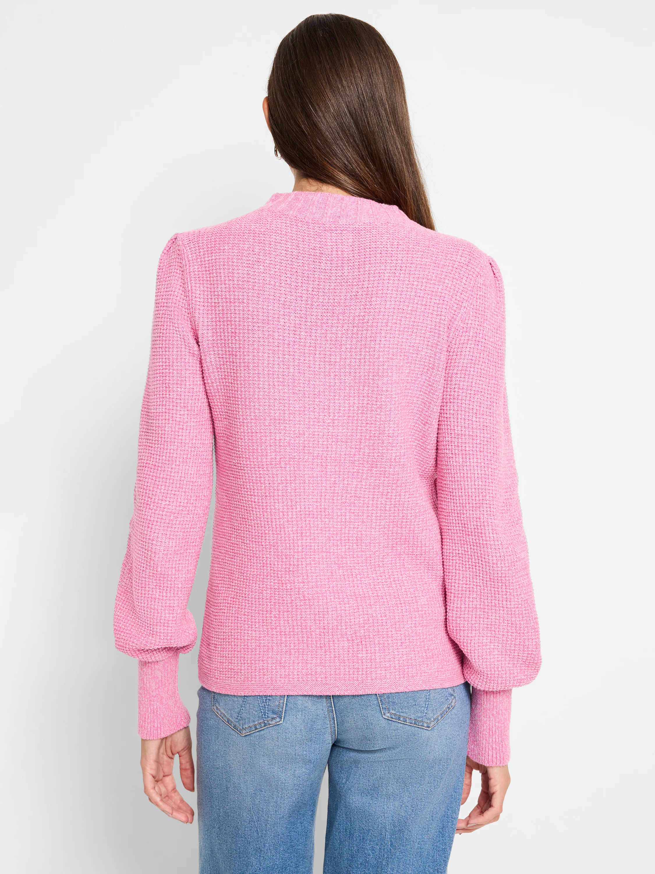 Pink waffle stitch sweater with a mock neck, puffed sleeves, and ribbed cuffs, shown from the back.