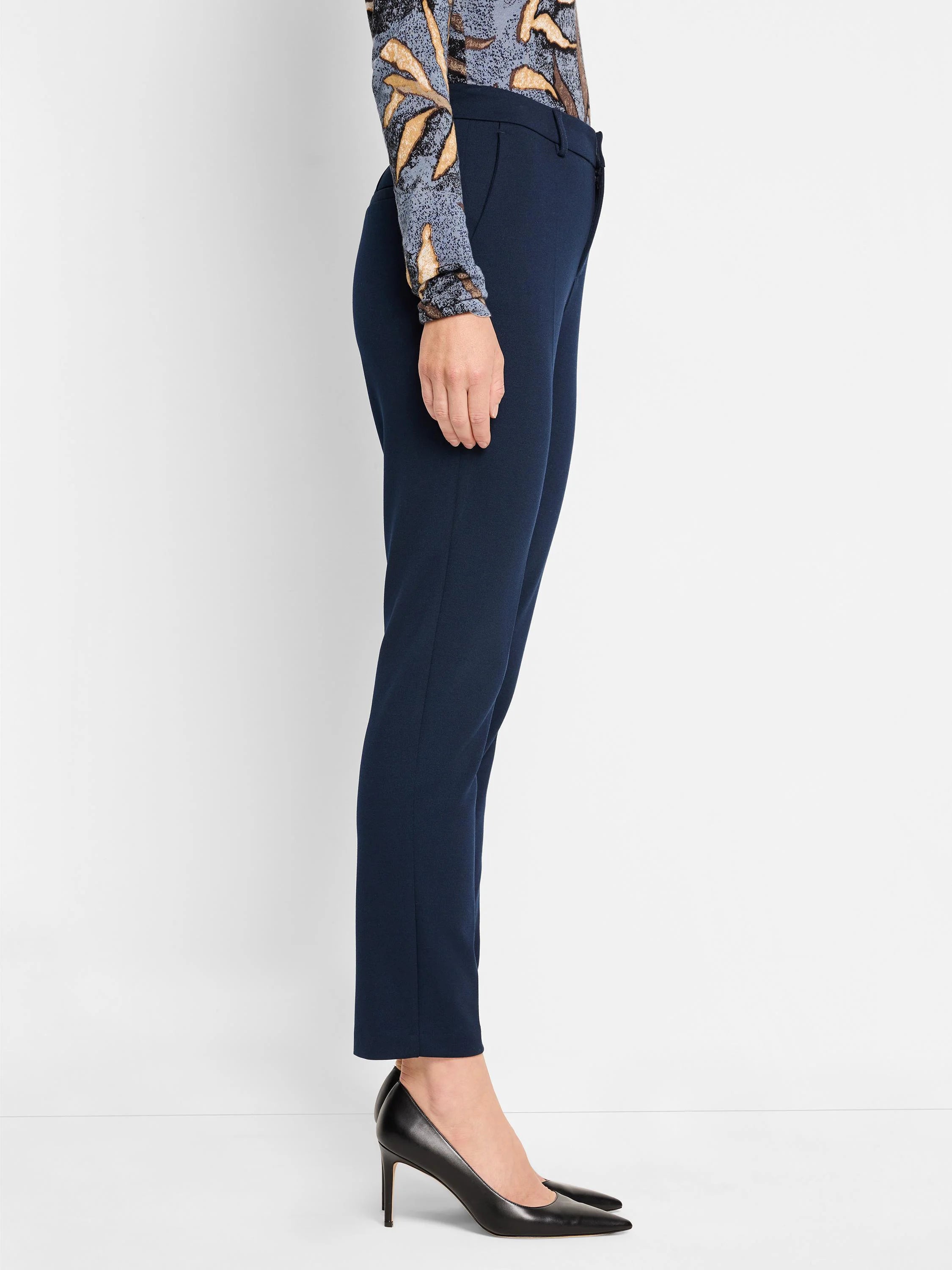 Navy blue Ponte knit trousers, ankle length, slim fit. Shown on a model.