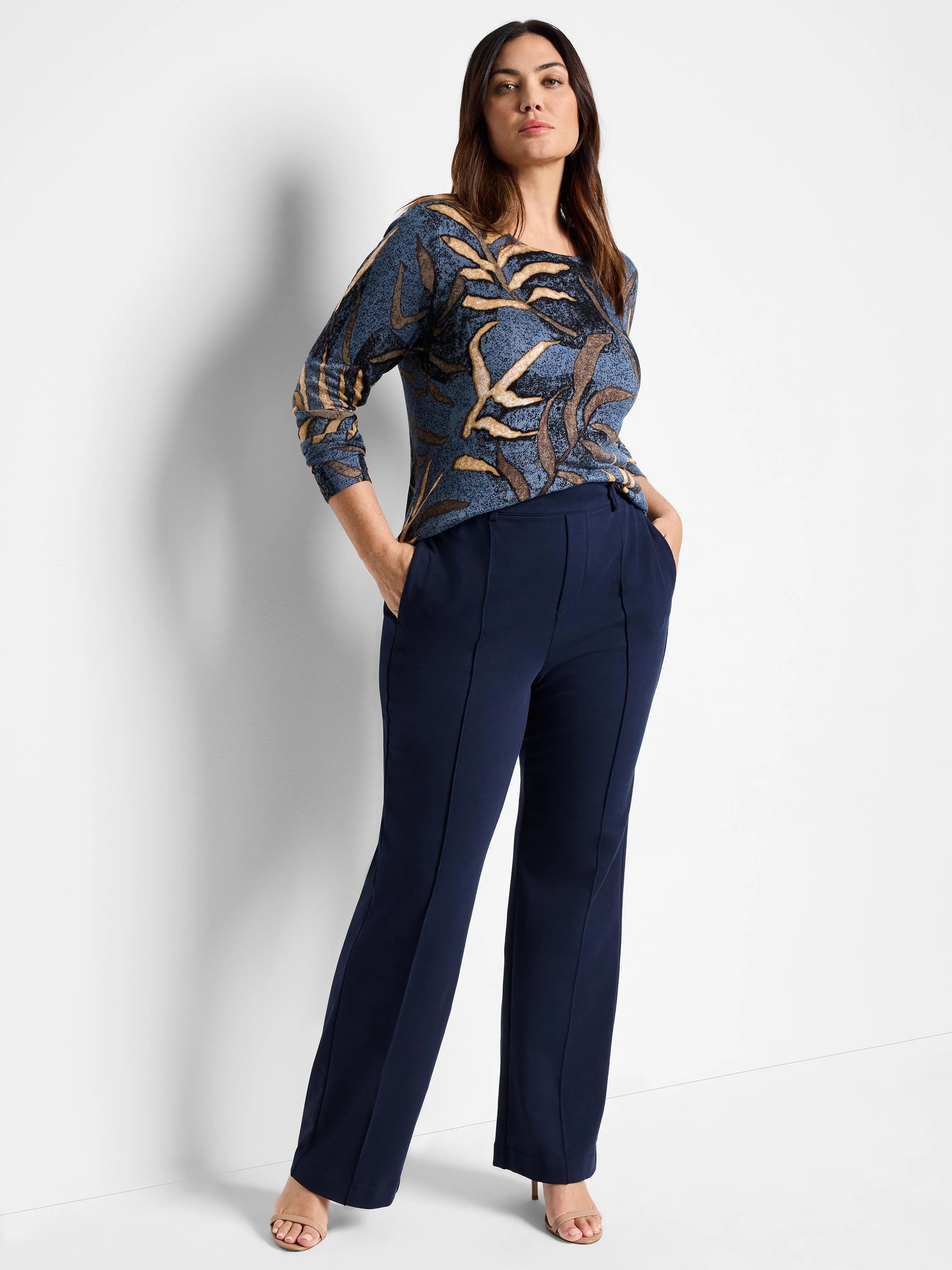 Navy blue wide-leg pleated pants shown on a model. The pants have center creases.