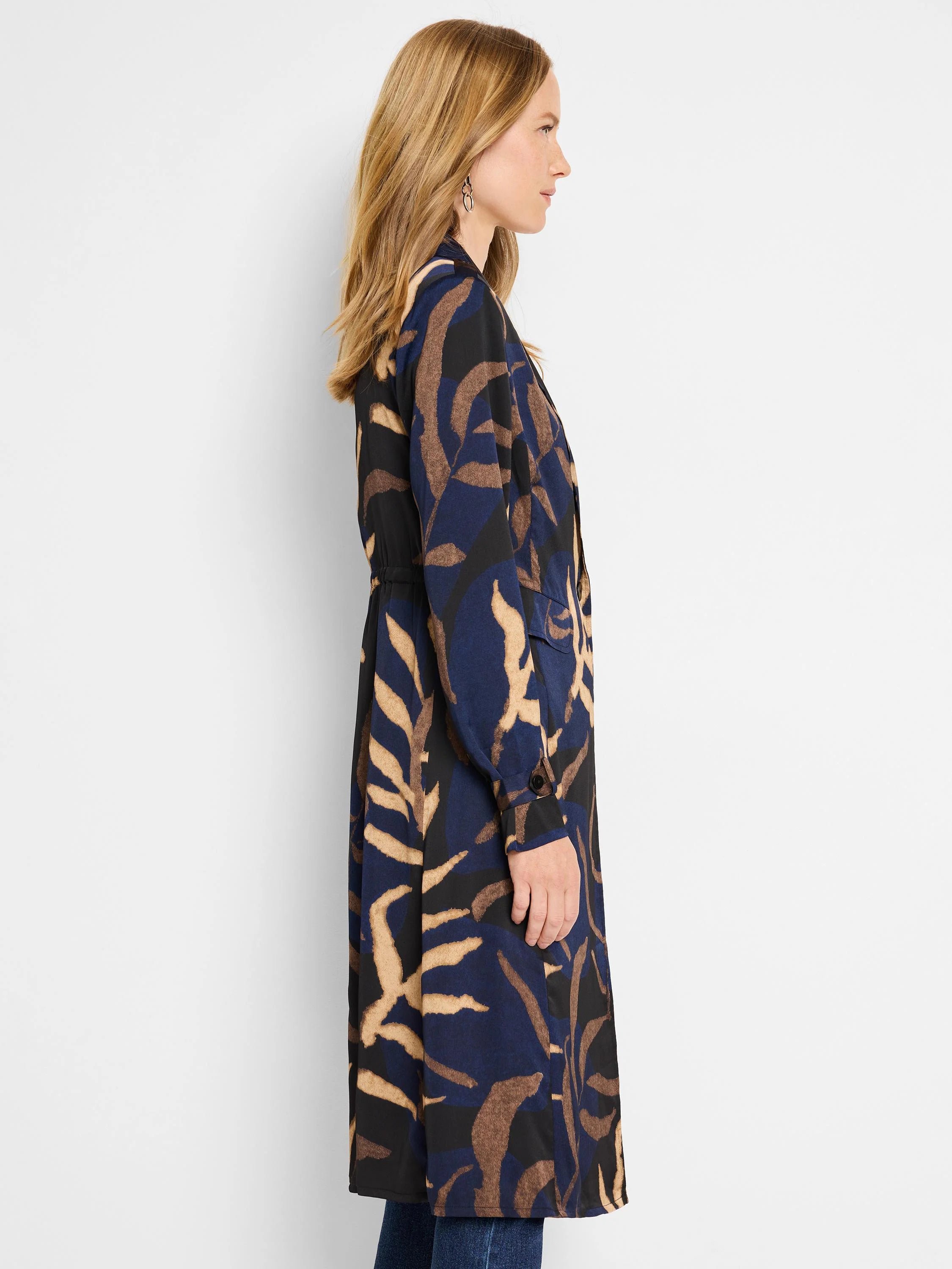 Navy, tan, and black abstract leaf print trench coat. Long sleeves, belted waist.