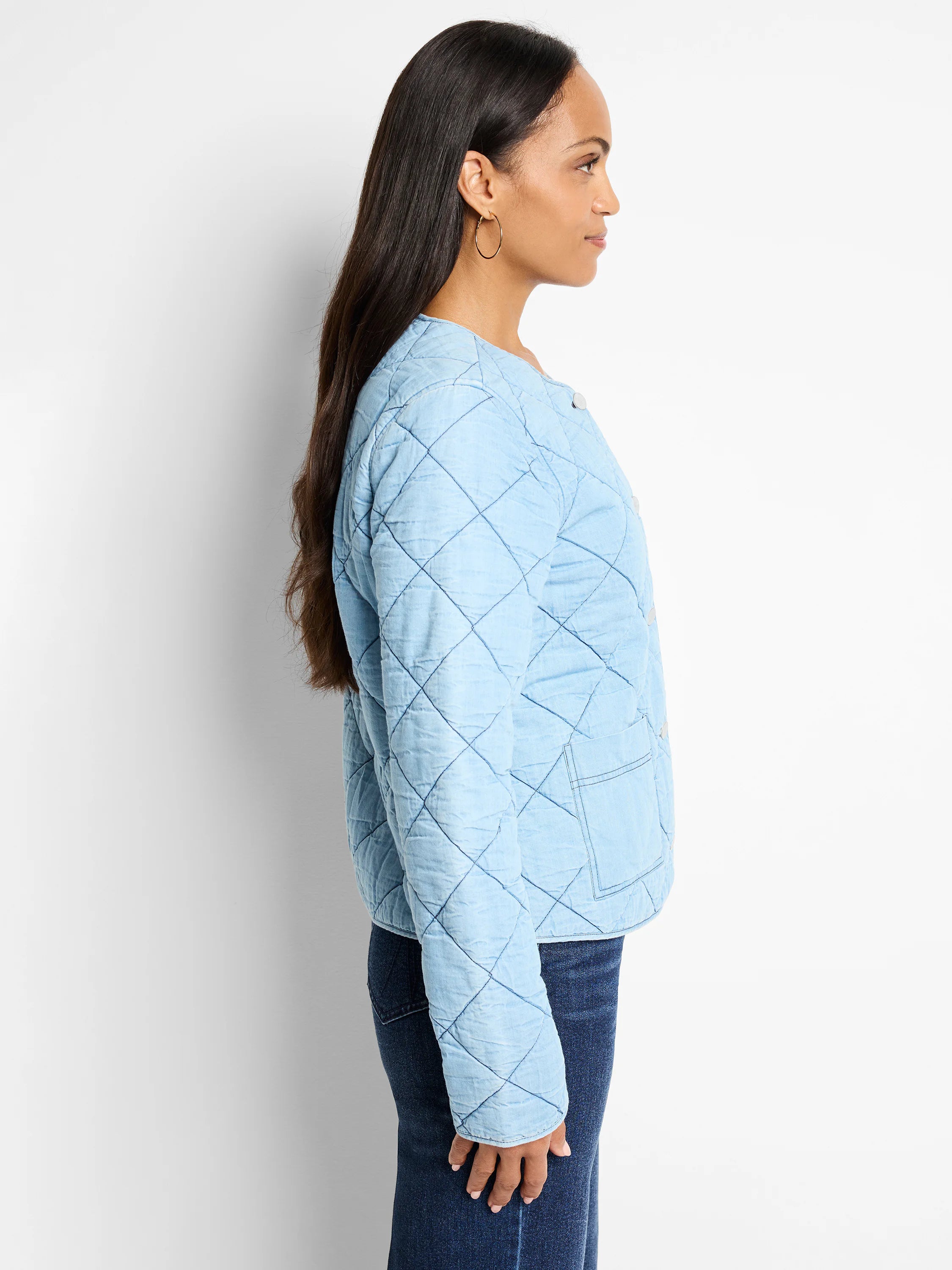 Light blue quilted denim jacket. Diamond quilting pattern. Small front pocket.