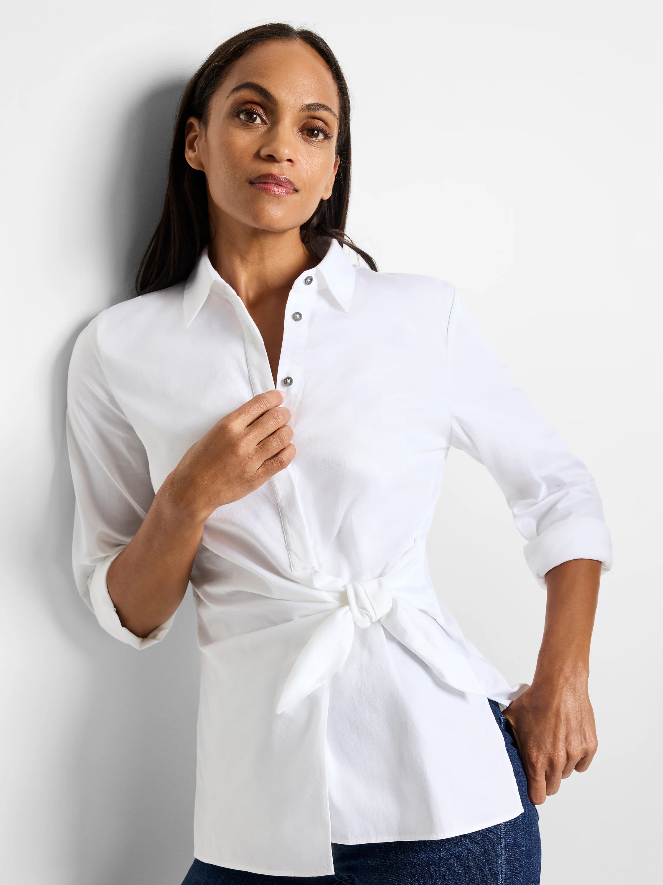 White, collared shirt with 3/4 sleeves. The shirt is tied at the waist. Silver buttons.