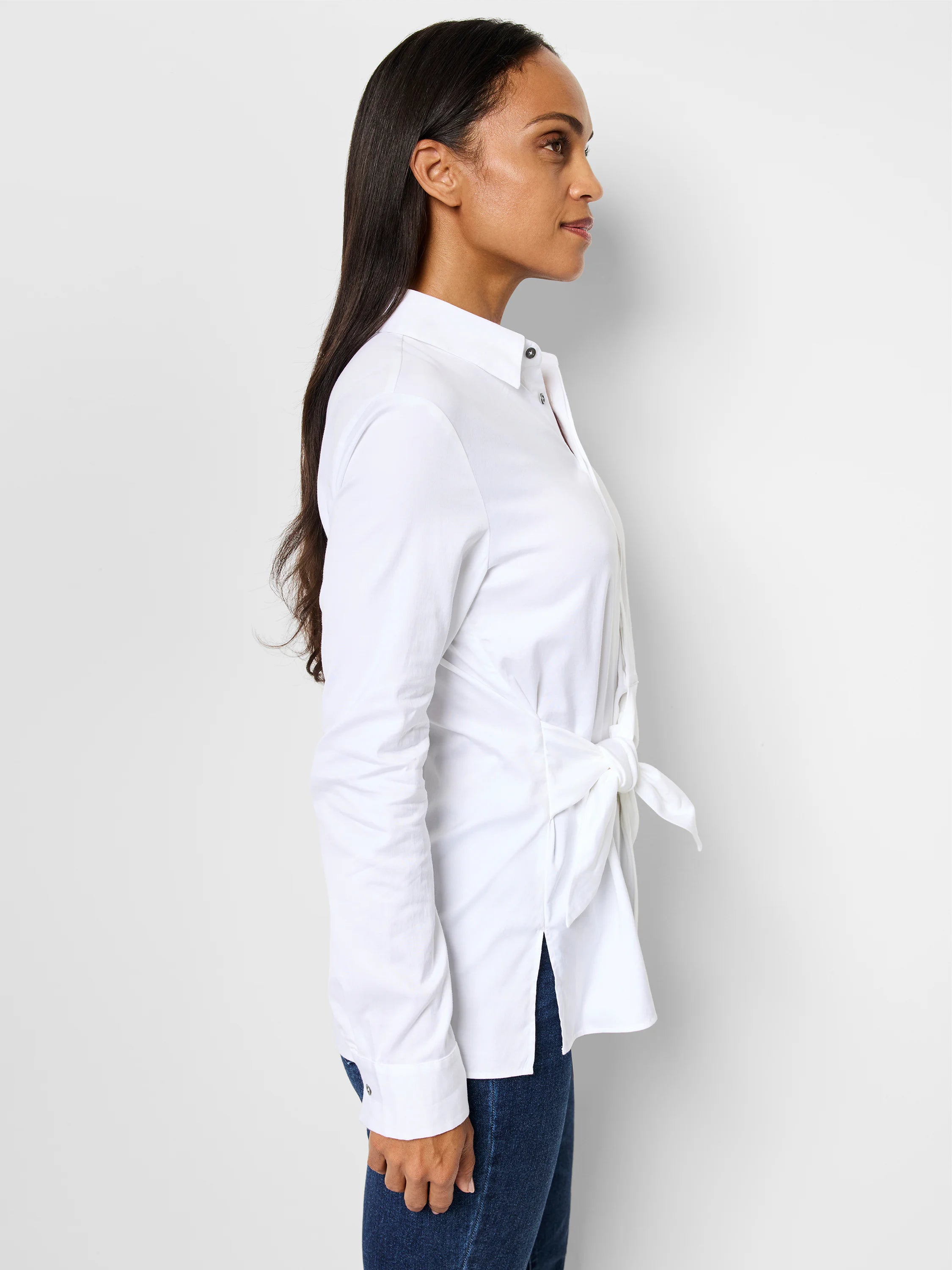 White long-sleeve collared shirt with side tie detail. The shirt is shown on a model.