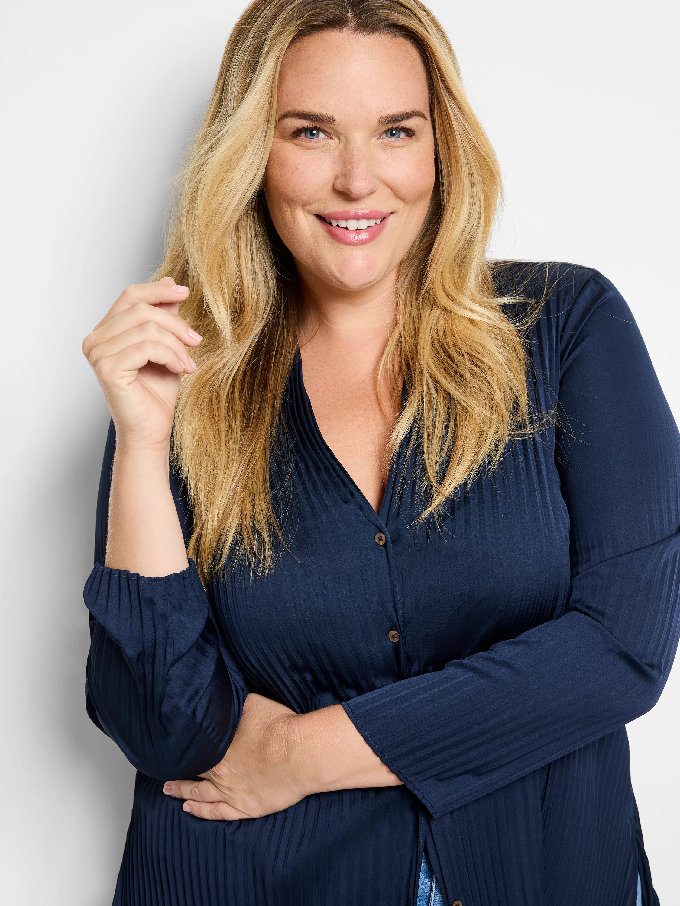 Navy blue, pleated, long-sleeve shirt with button front. Vertical lines throughout.