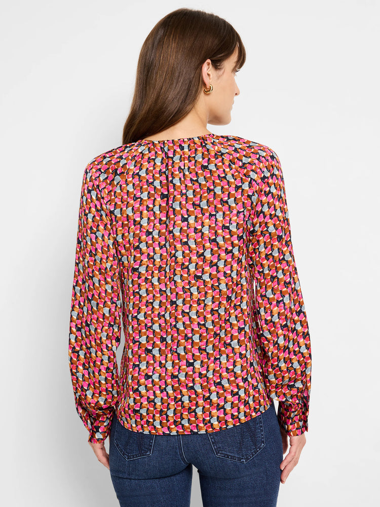 Long-sleeved top, pink, brown, and gray geometric pattern on a dark background. Slight V-neck.