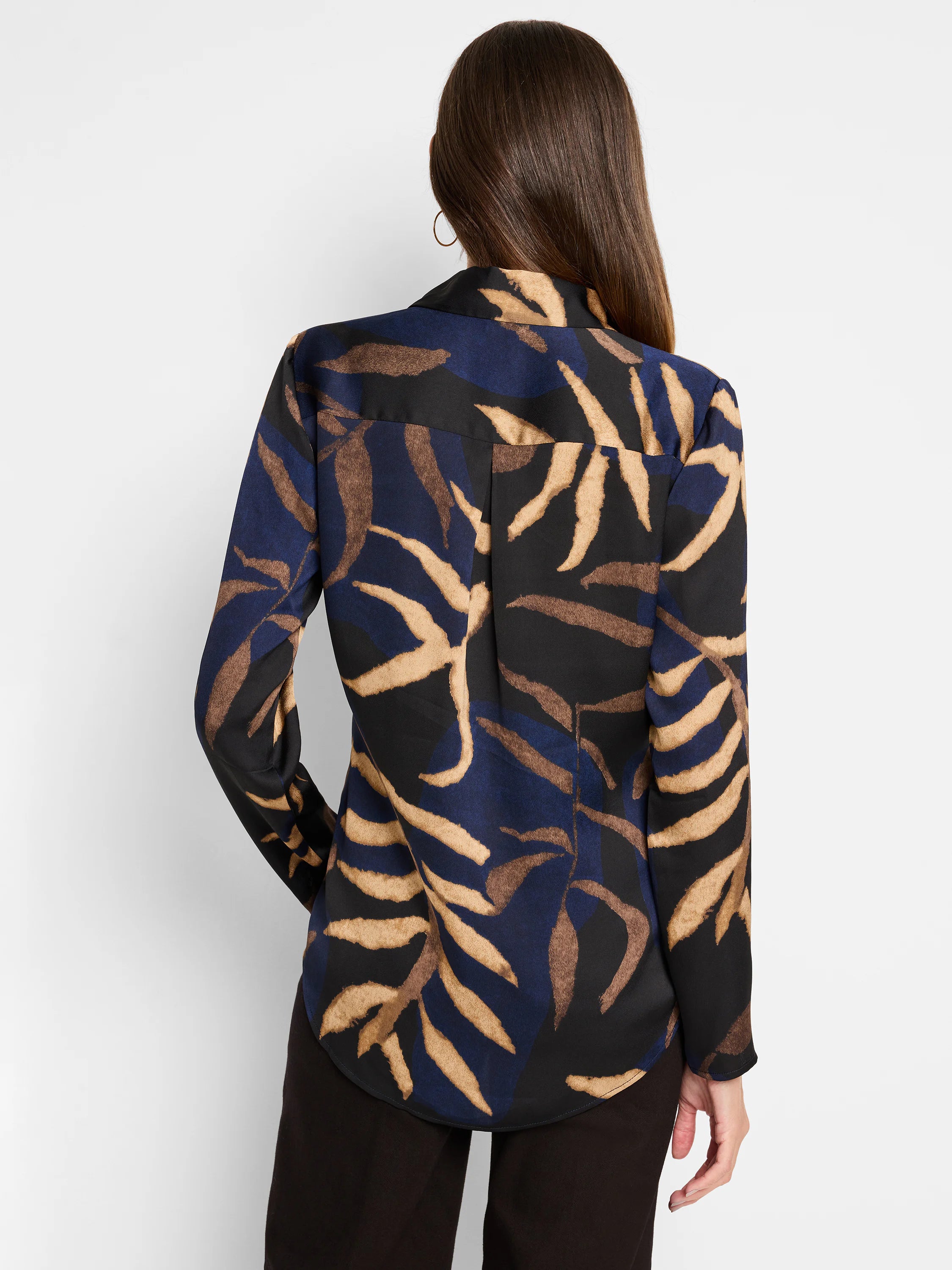 Long-sleeved blouse, dark navy, black, and tan leaf pattern. Back view.
