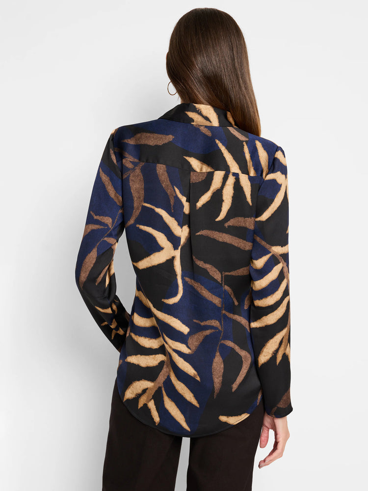 Long-sleeved blouse, dark navy, black, and tan leaf pattern. Back view.