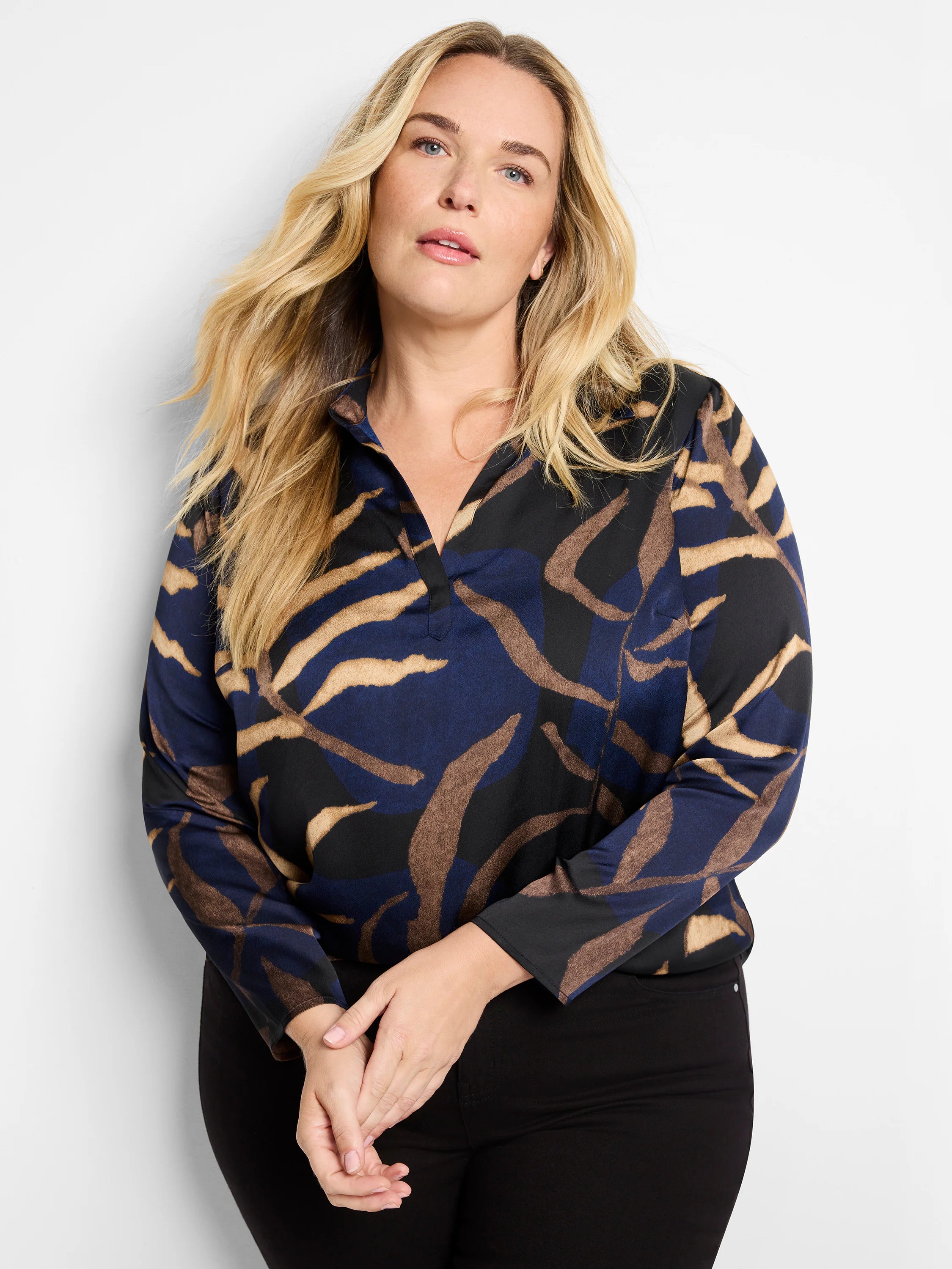 Long-sleeved top, navy, black, and tan abstract print. Collared neckline.