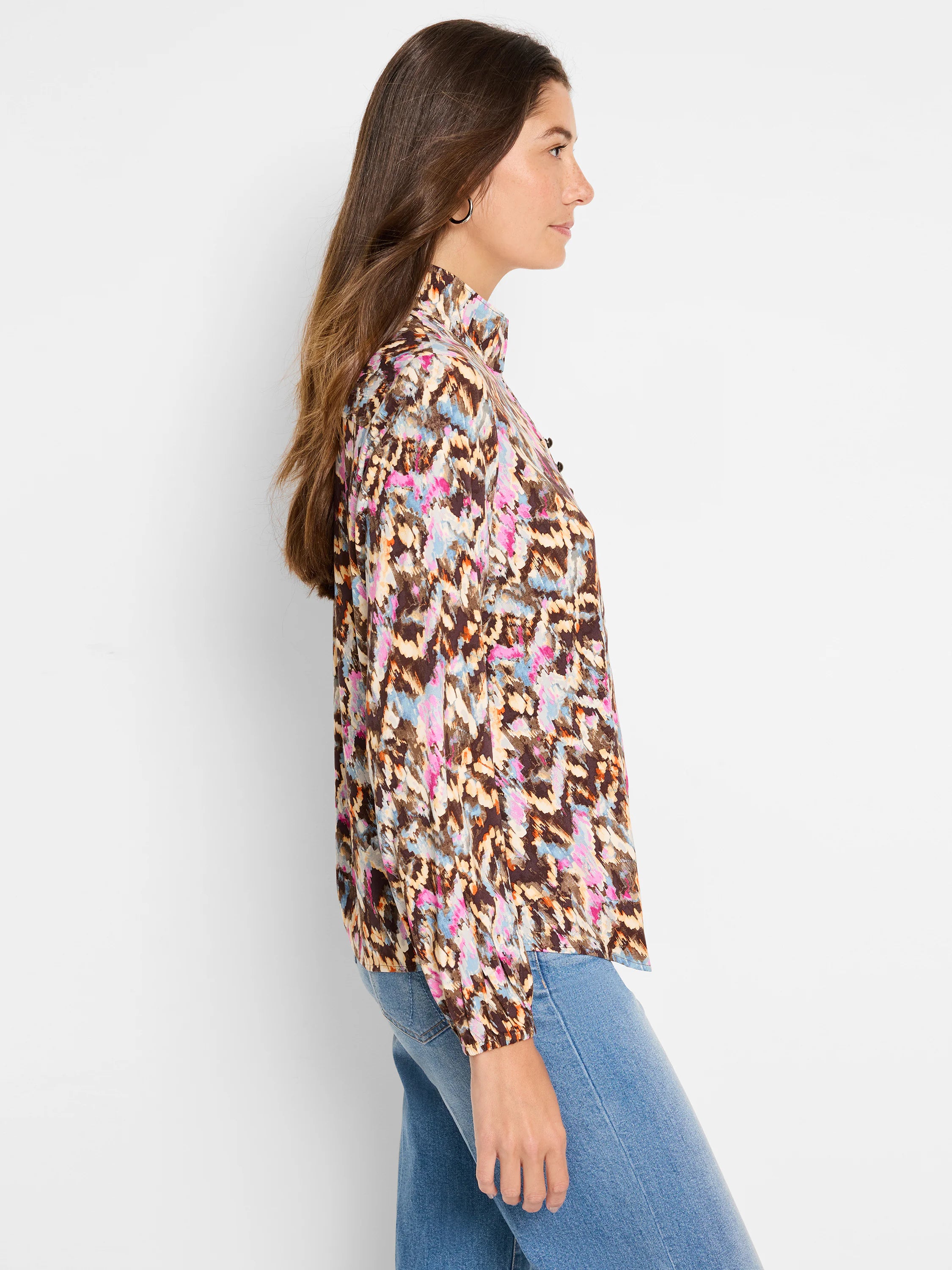 Brown long-sleeve blouse with pink, blue, and beige ikat pattern. Mock neck.