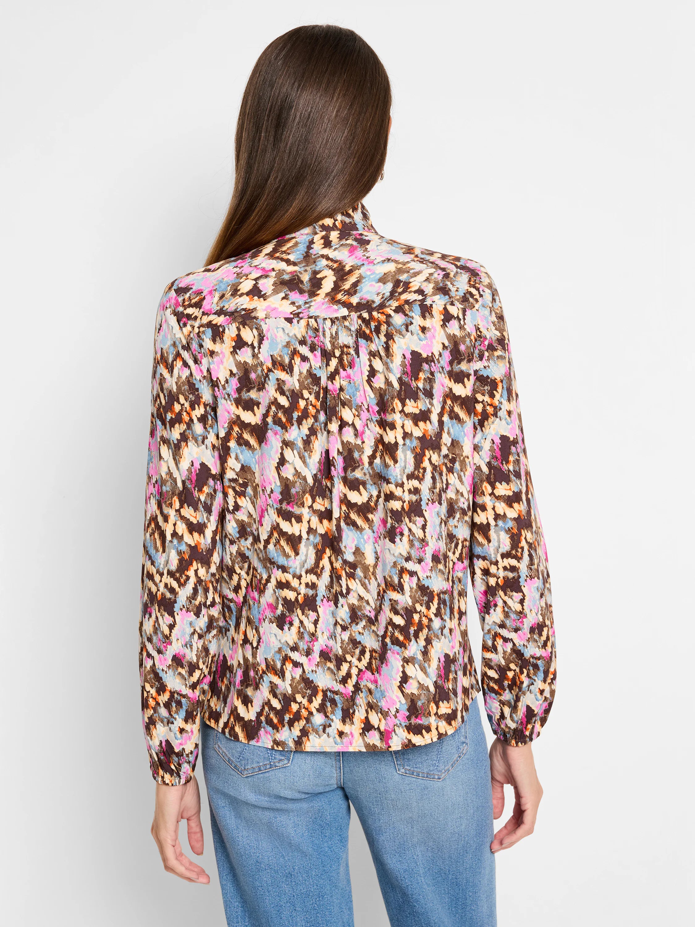 Brown, beige, pink, and blue abstract print long-sleeve blouse with a high neck.