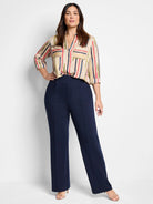 Beige blouse with painted vertical stripes in red, blue, green, and yellow. V-neck, chest pockets, 3/4 rolled sleeves.