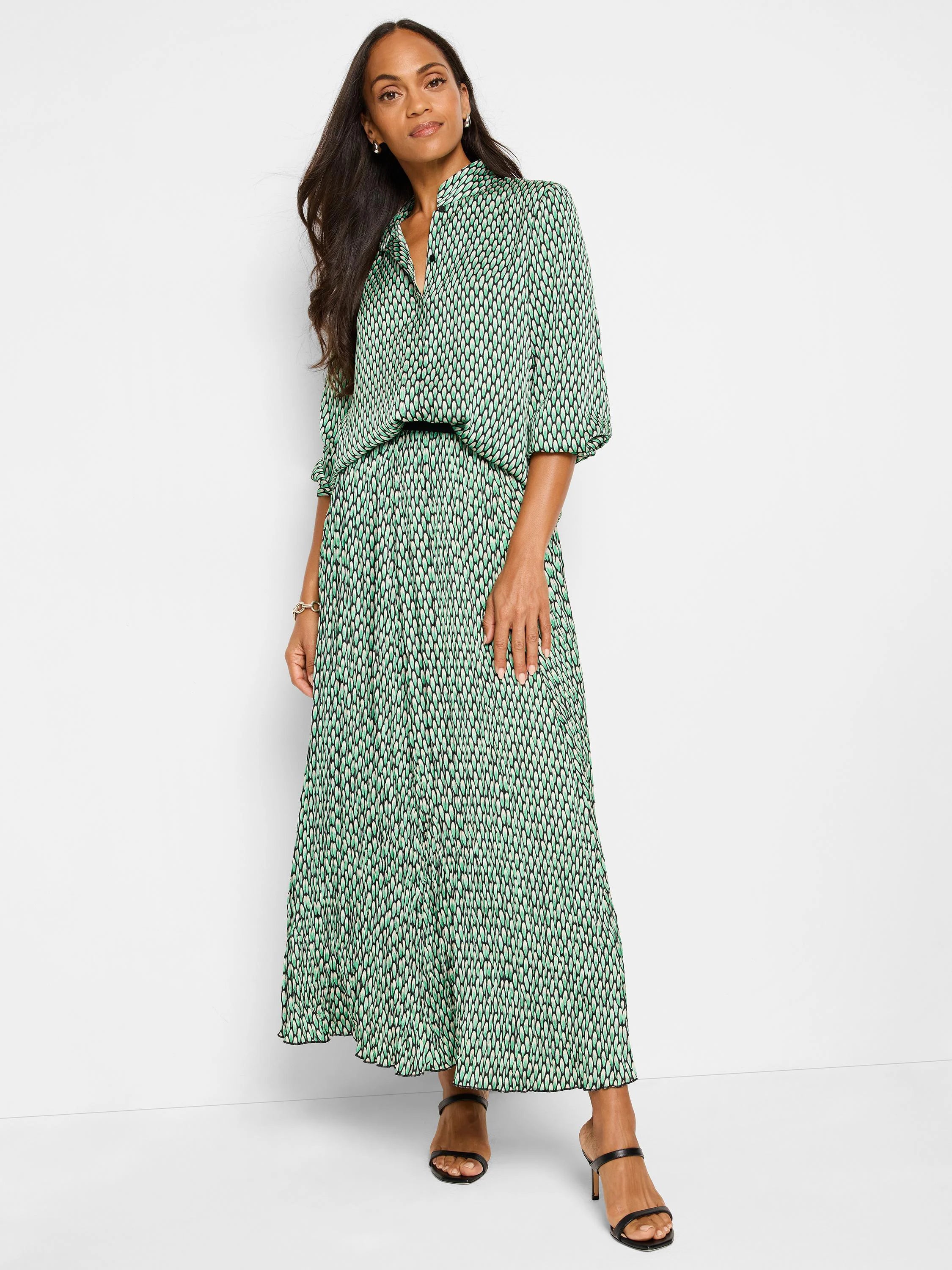 Green, black, and white abstract dot print top and maxi skirt. Pleated skirt. Three-quarter sleeves.