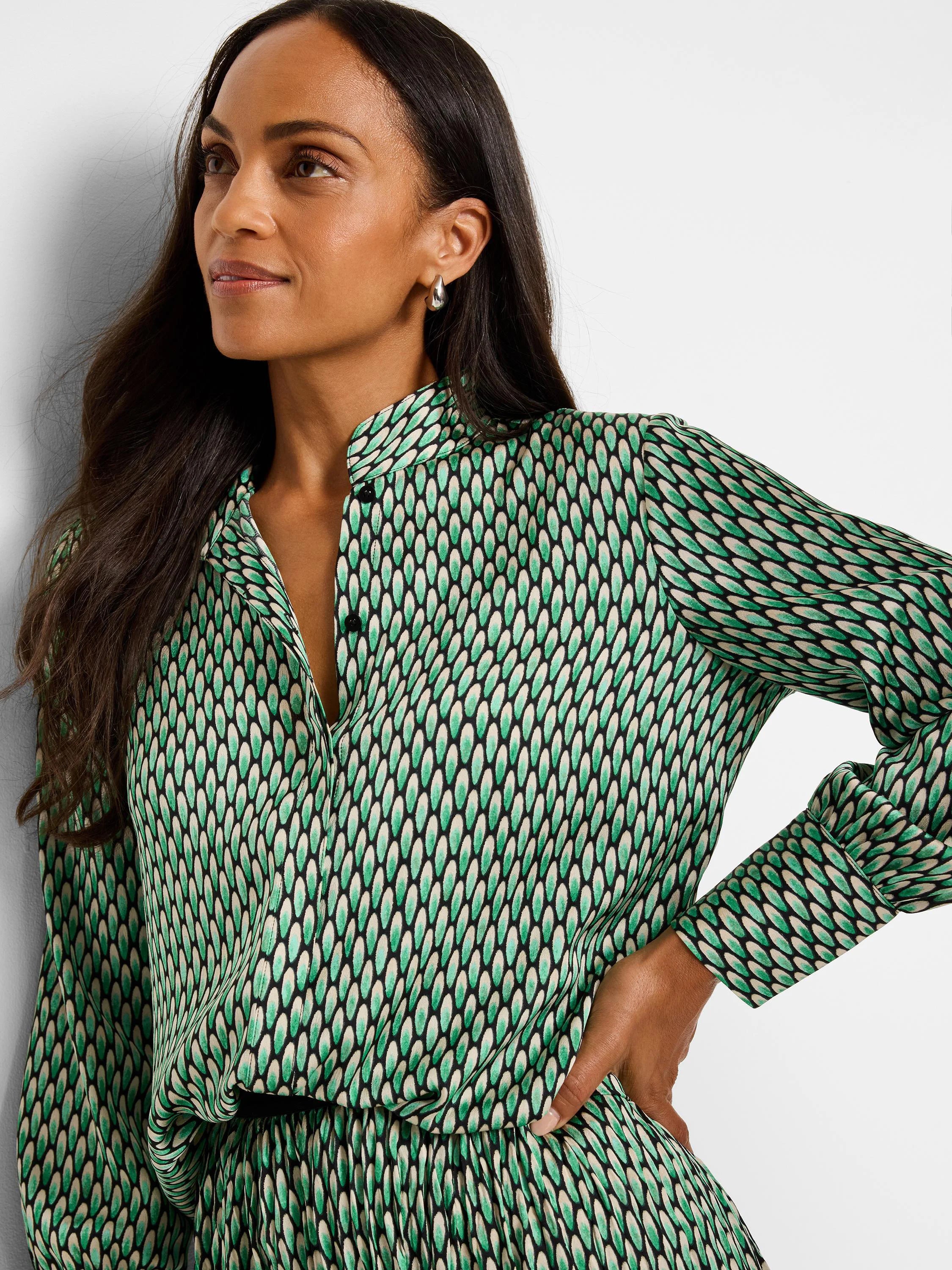 Green, cream, and black abstract dot print long-sleeve button-down top.