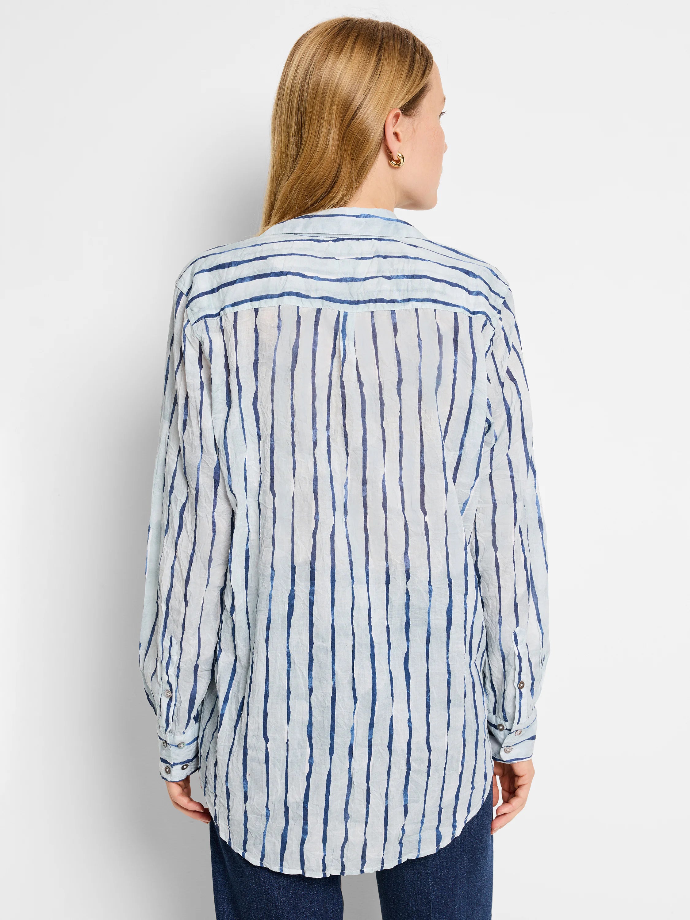 Blue and white vertical striped shirt; light blue background, darker blue uneven stripes. Long sleeves, relaxed fit.