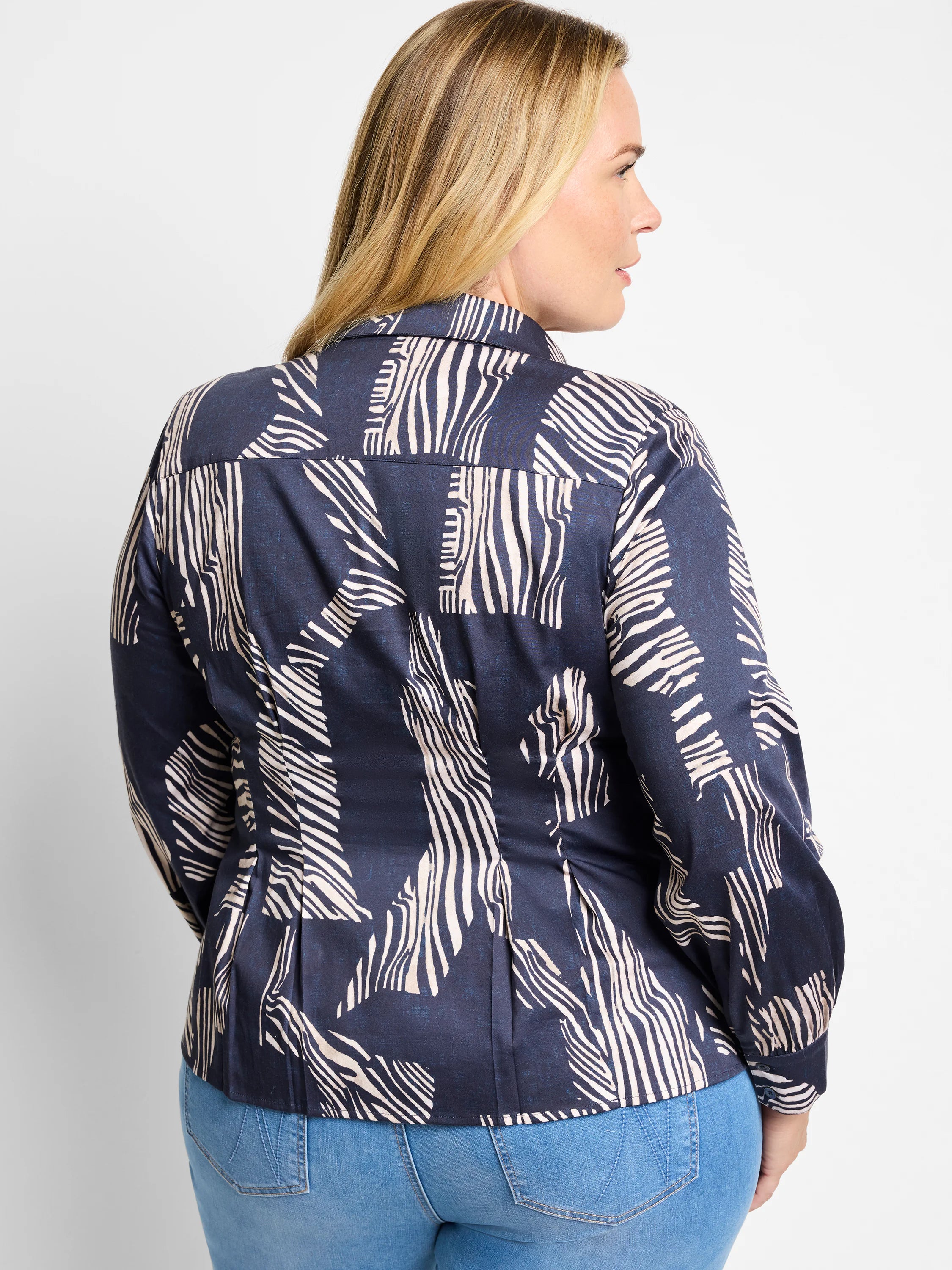 Dark navy shirt with off-white zebra stripes in an abstract pattern. Long sleeves, collared.