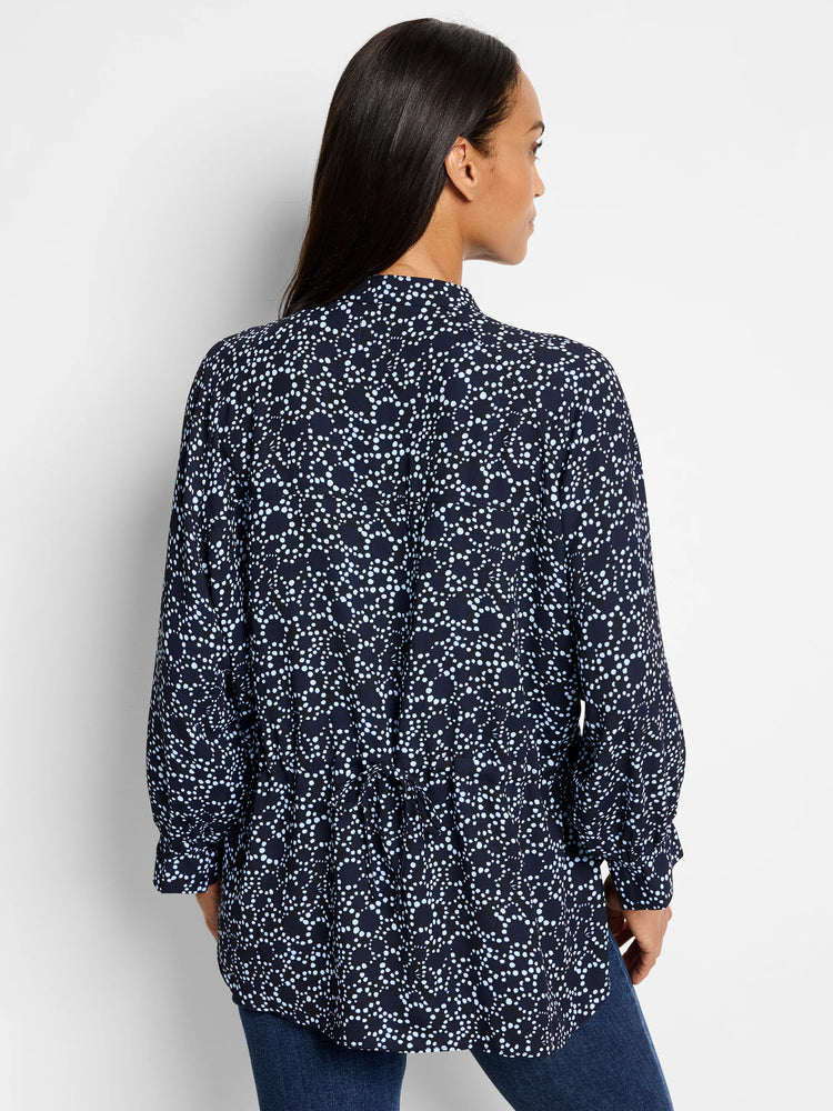Dark navy top with a light blue polka dot pattern. Long sleeves, high neck.