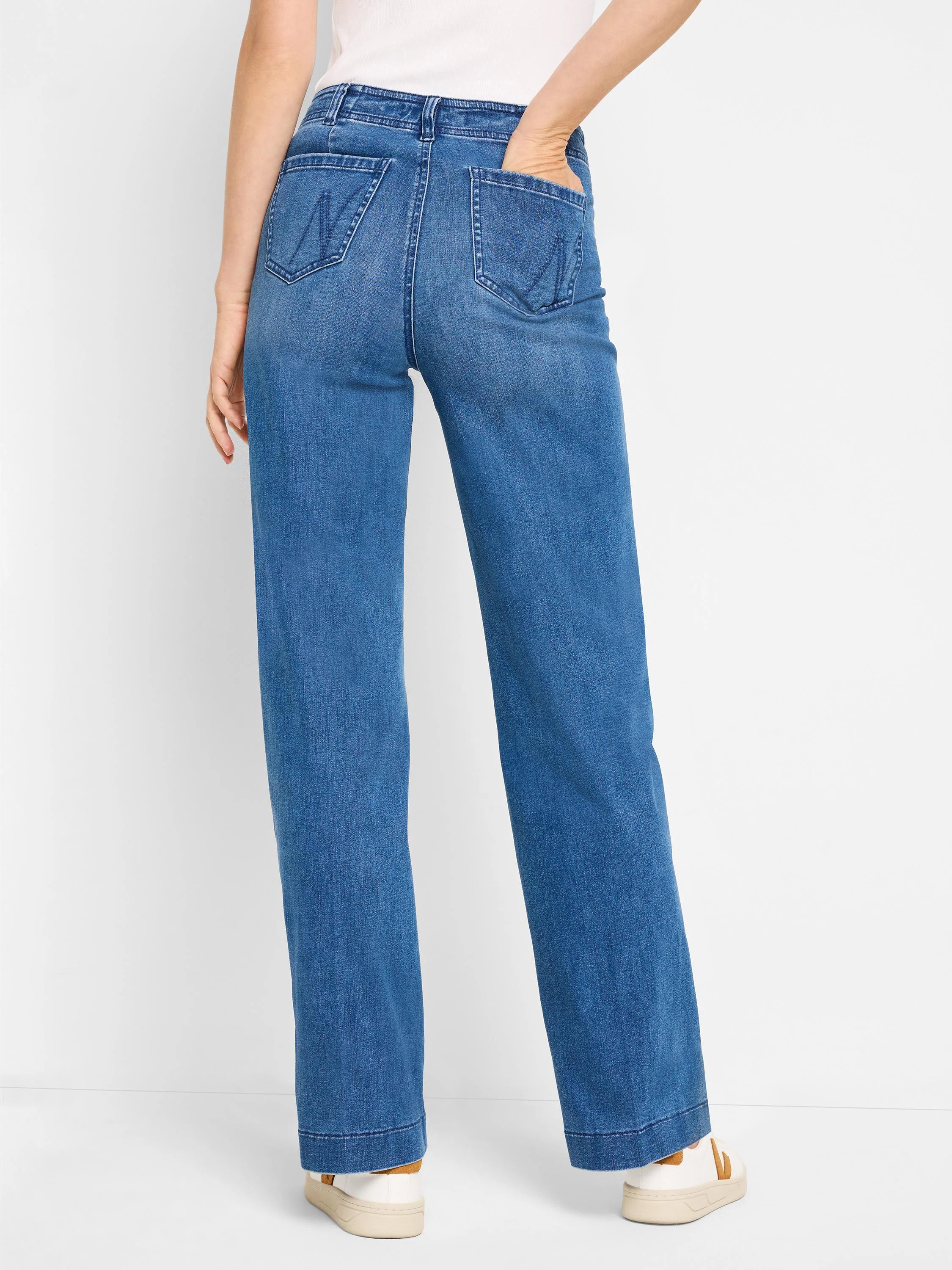 Medium blue high-rise wide-leg jeans shown from behind. Features two back pockets with a hand in one.