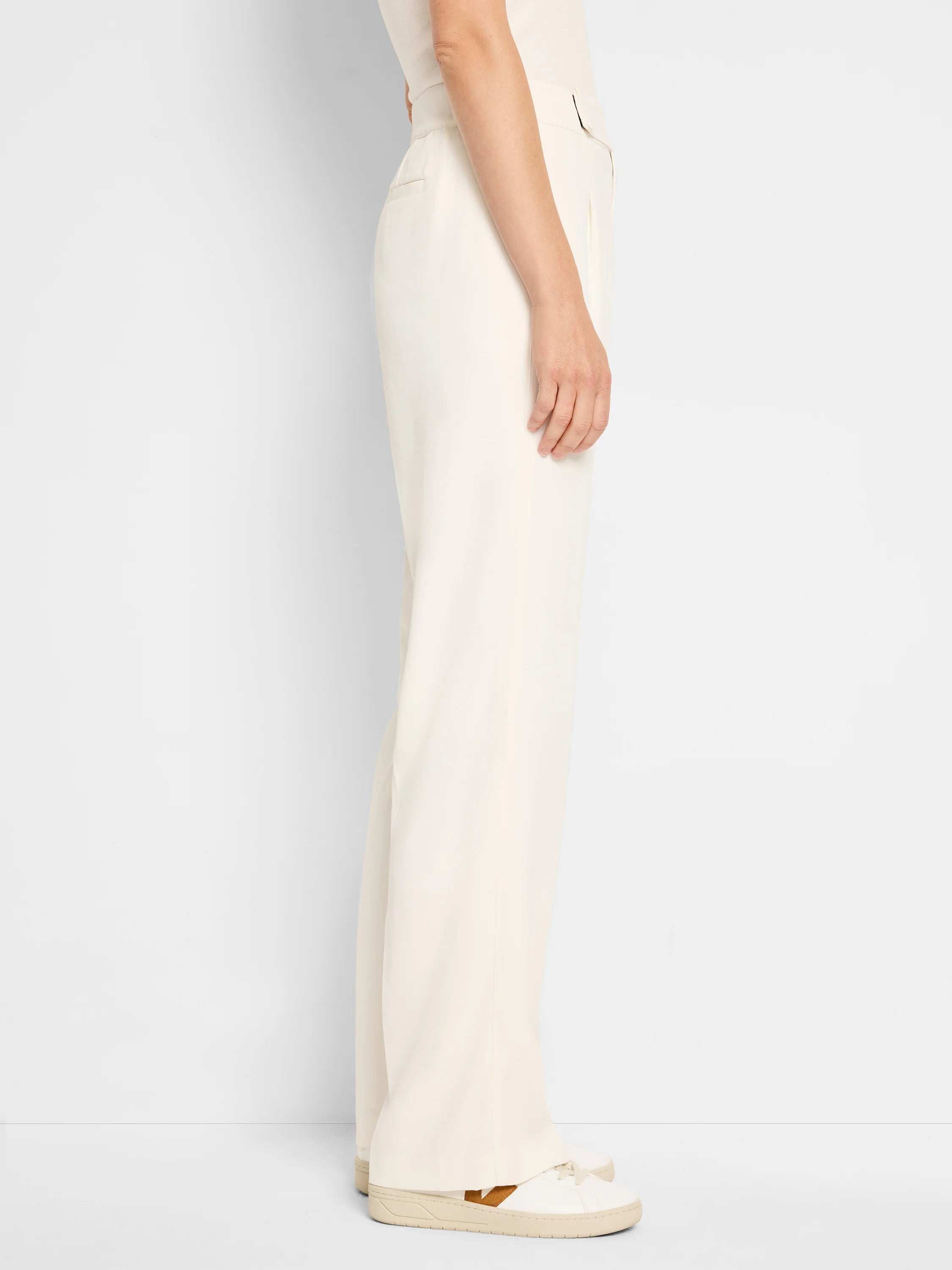 Off-white wide-leg trousers; pleated front, shown on a model.