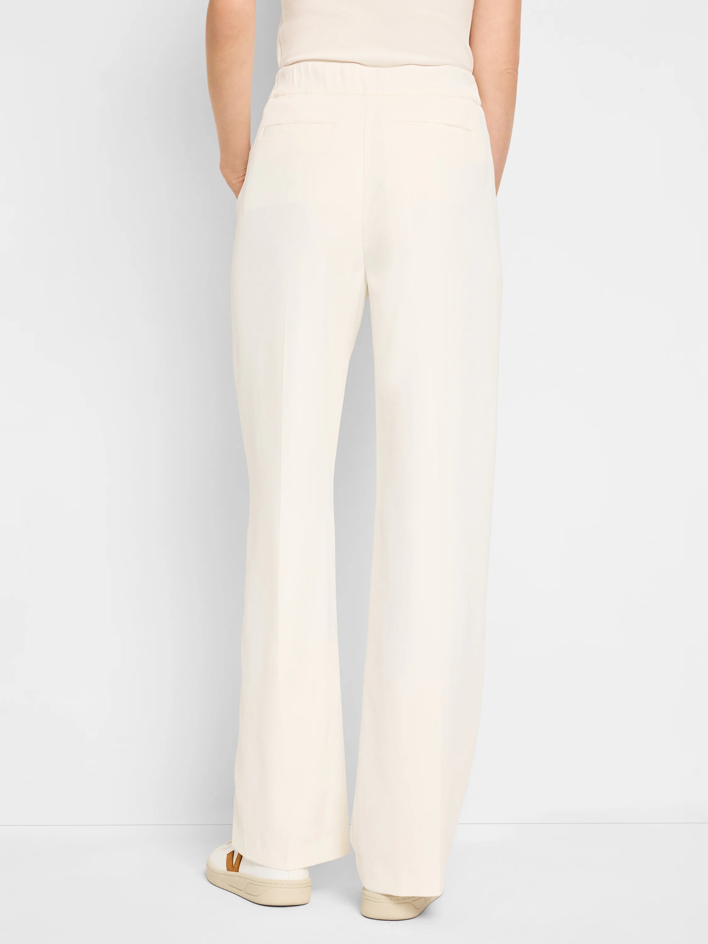 Off-white wide-leg trousers, pull-on waist. Back view.