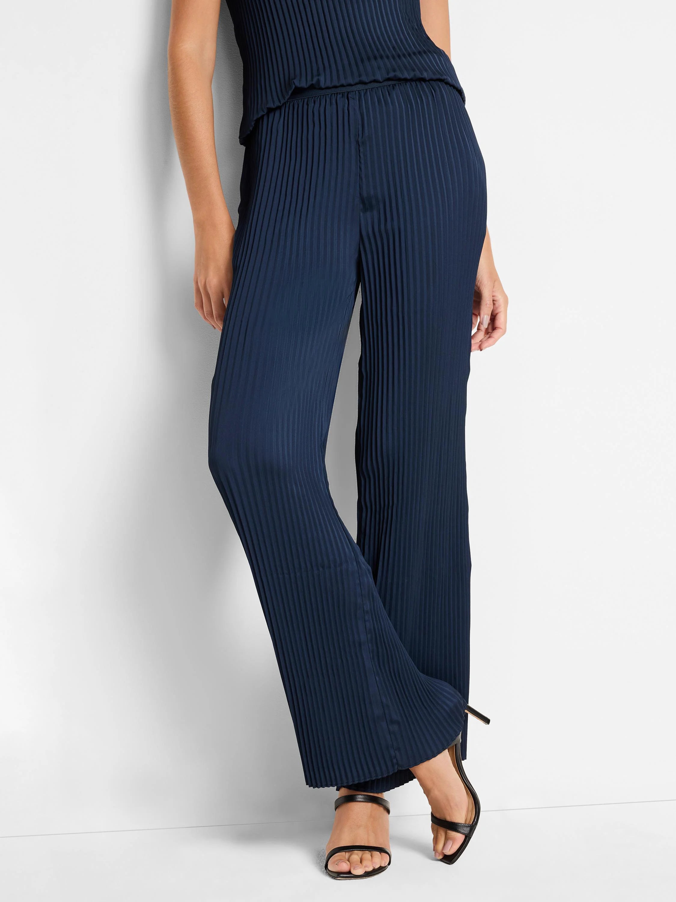 Navy blue, wide-leg pants with thin, vertical pleats. Full length.