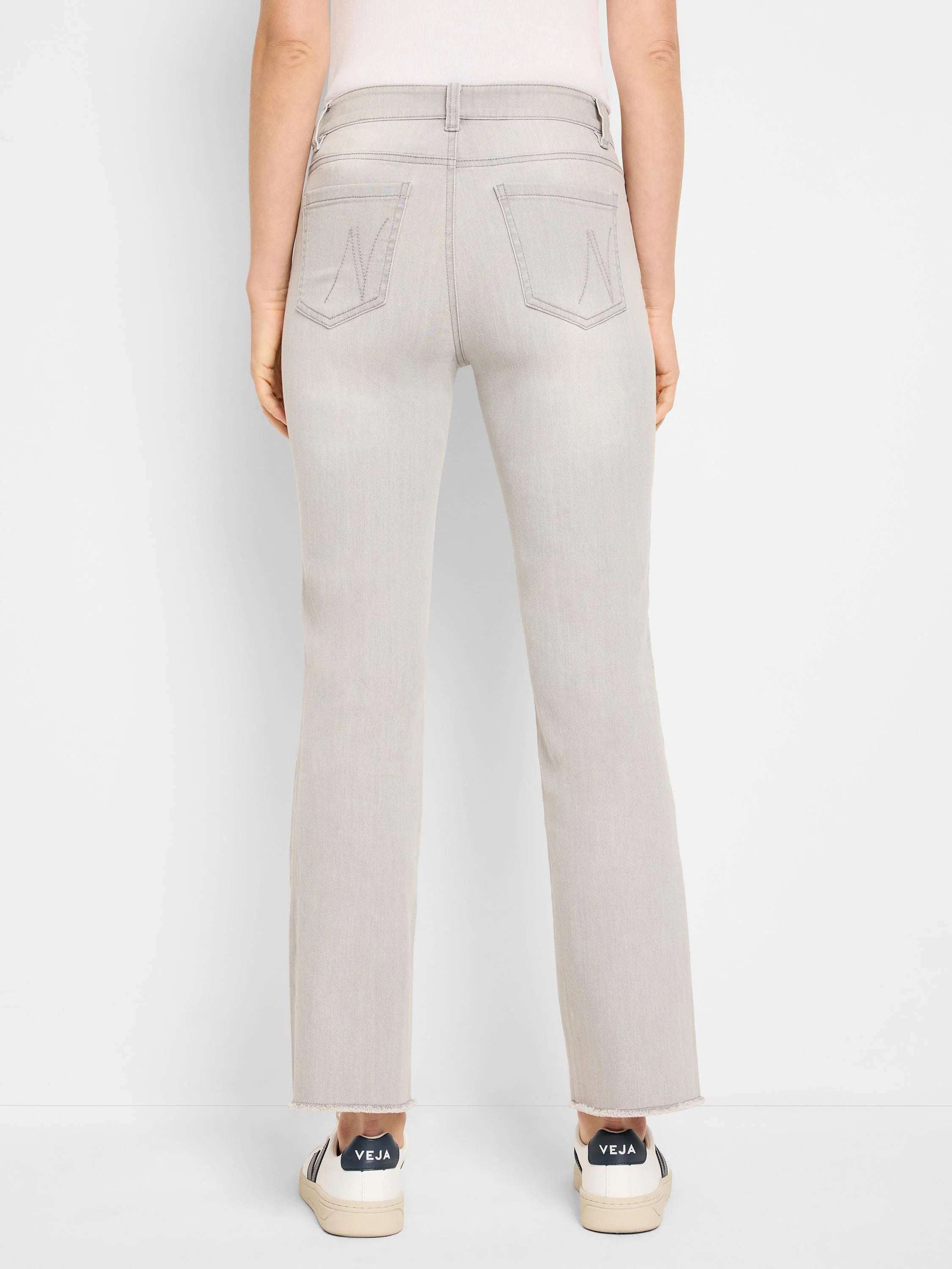 Light grey, faded demi boot jeans, back view, with decorative back pocket stitching and frayed hems.