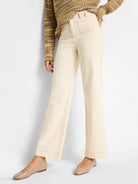 Cream wide-leg high-rise jeans with visible brown contrast stitching on front patch pockets, waistband, and seams.