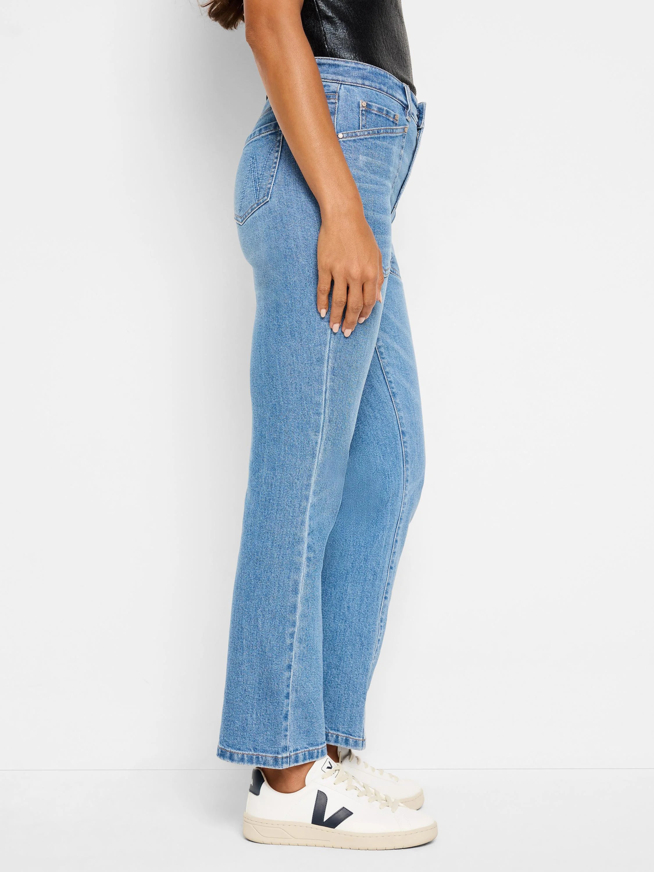 Light wash denim jeans; bootcut; side view.