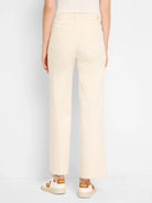 Cream wide-leg jeans, high-waisted, with two back pockets and frayed raw hems, shown from behind.