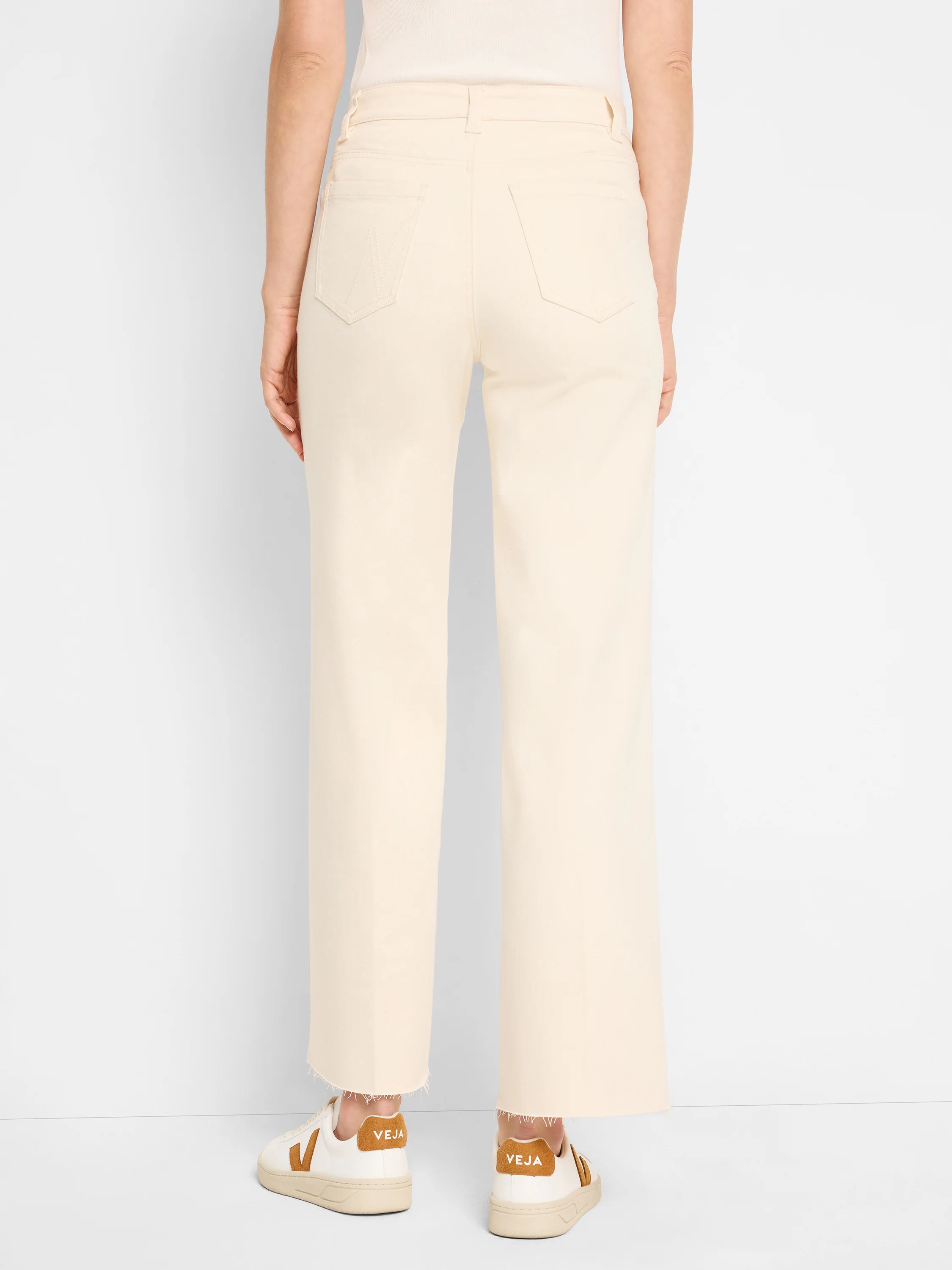 Cream wide-leg jeans, high-waisted, with two back pockets and frayed raw hems, shown from behind.