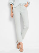 Faded light blue straight ankle jeans, ending above the ankle.