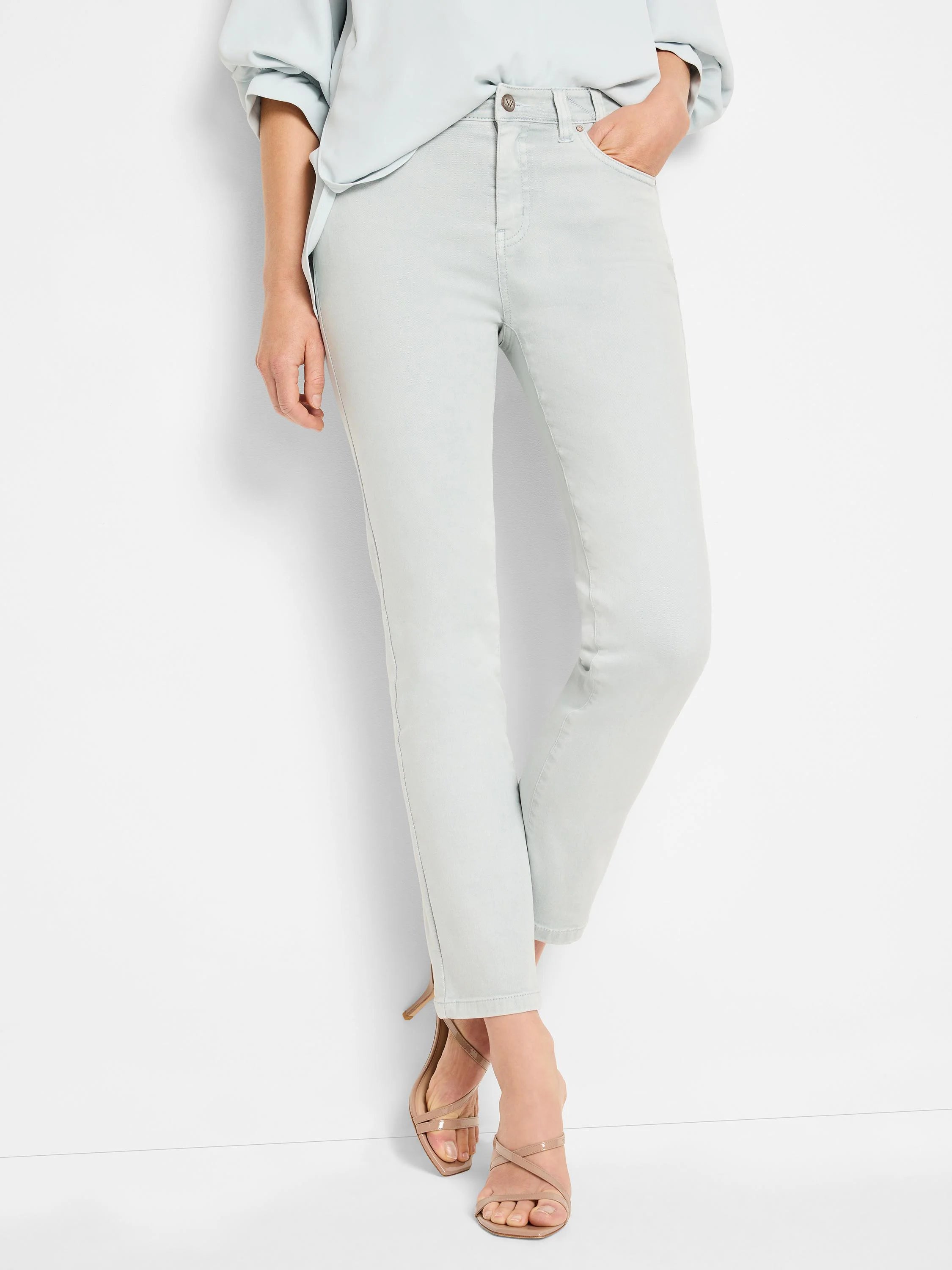 Faded light blue straight ankle jeans, ending above the ankle.