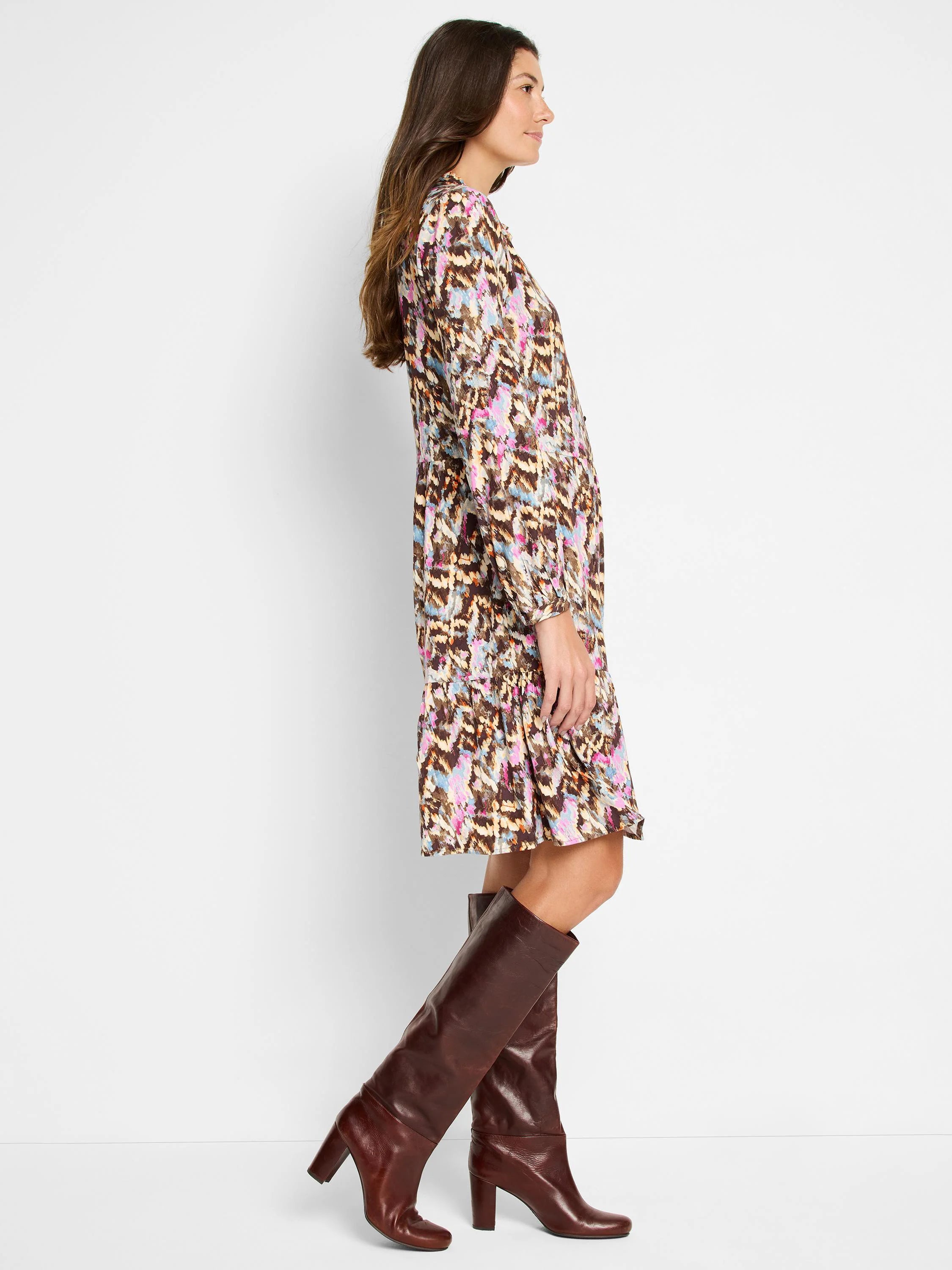 Brown midi dress with pink, blue, and beige abstract print. Long sleeves, collared neckline.