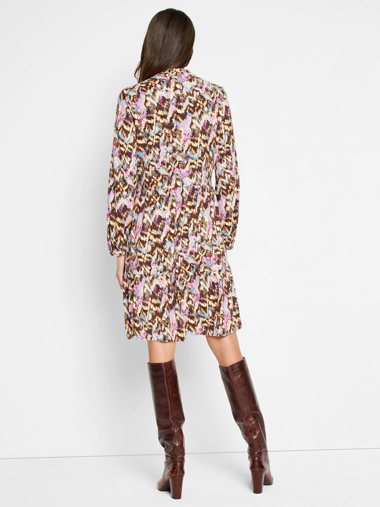 Brown mini dress with pink, blue, and beige abstract print. Long sleeves, tiered skirt.