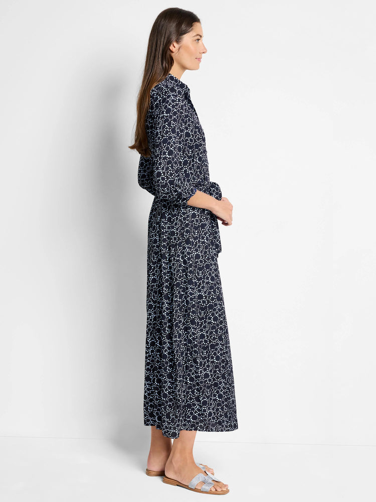 Navy maxi dress with light blue dot pattern, belted waist, and three-quarter sleeves.