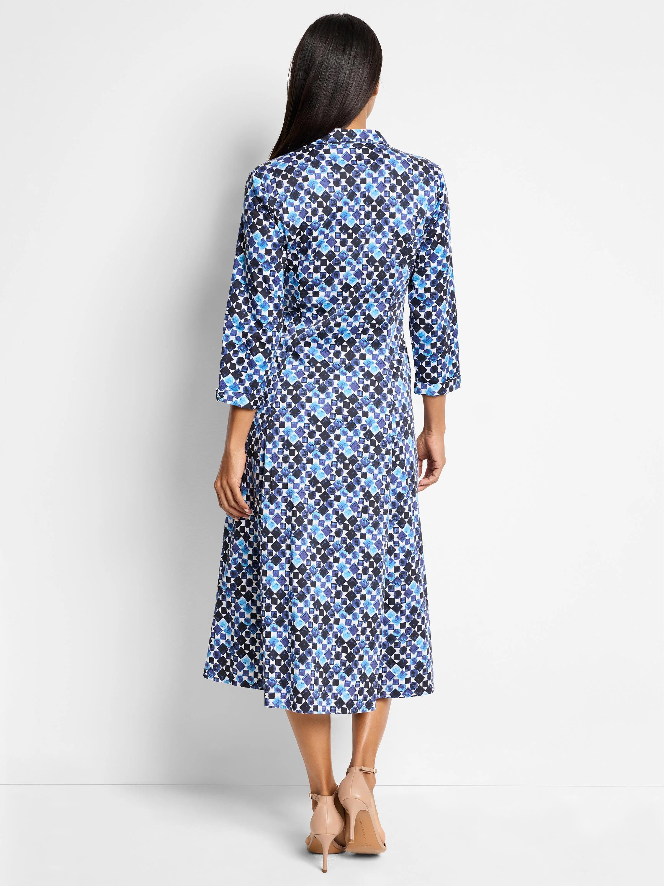 Blue and white patterned midi shirt dress. Geometric print with darker and lighter blues. Three-quarter sleeves, collared.
