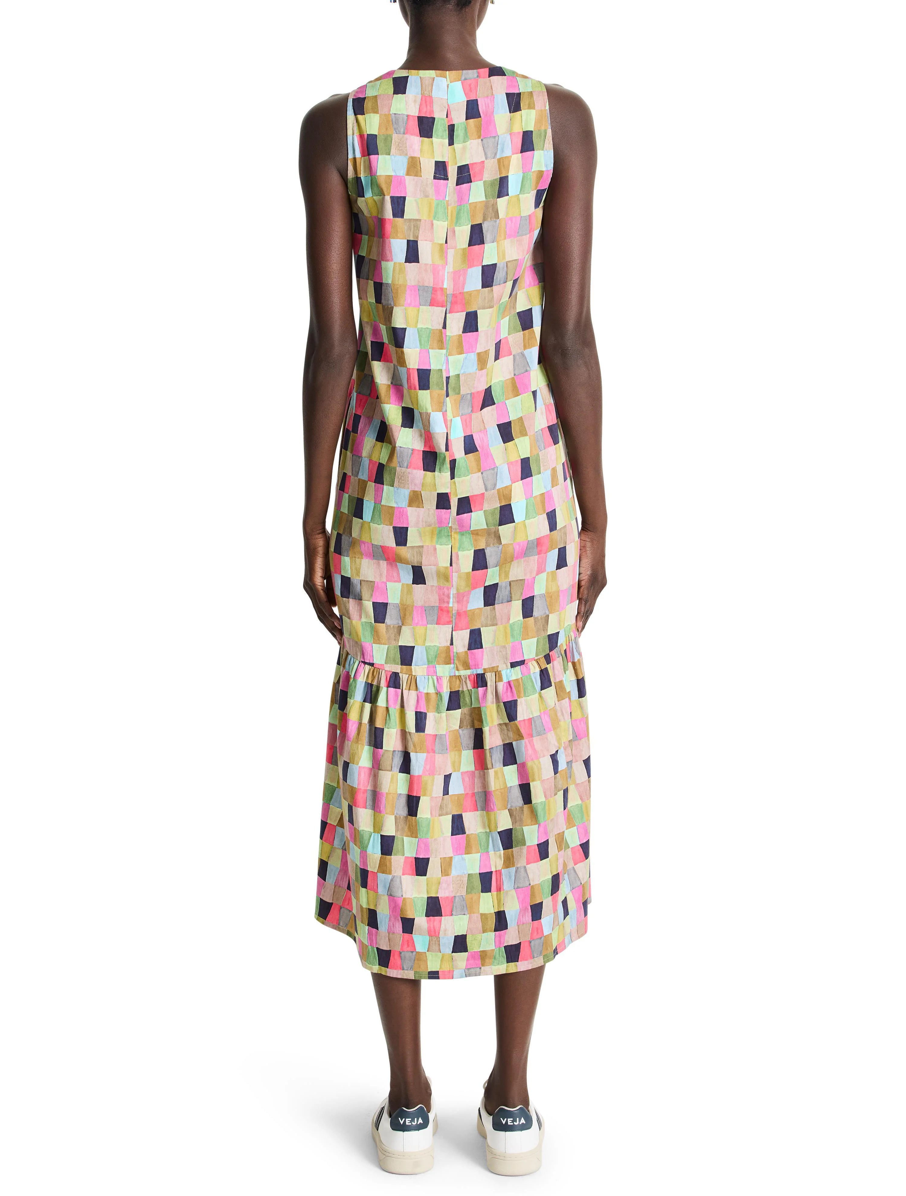 Sleeveless midi dress, multicolored geometric patchwork print. Greens, pinks, beige, and blues predominate. Features a...