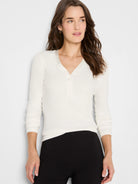 Cream ribbed V-neck top with a 3-button henley placket and subtle smooth trim on the neckline.