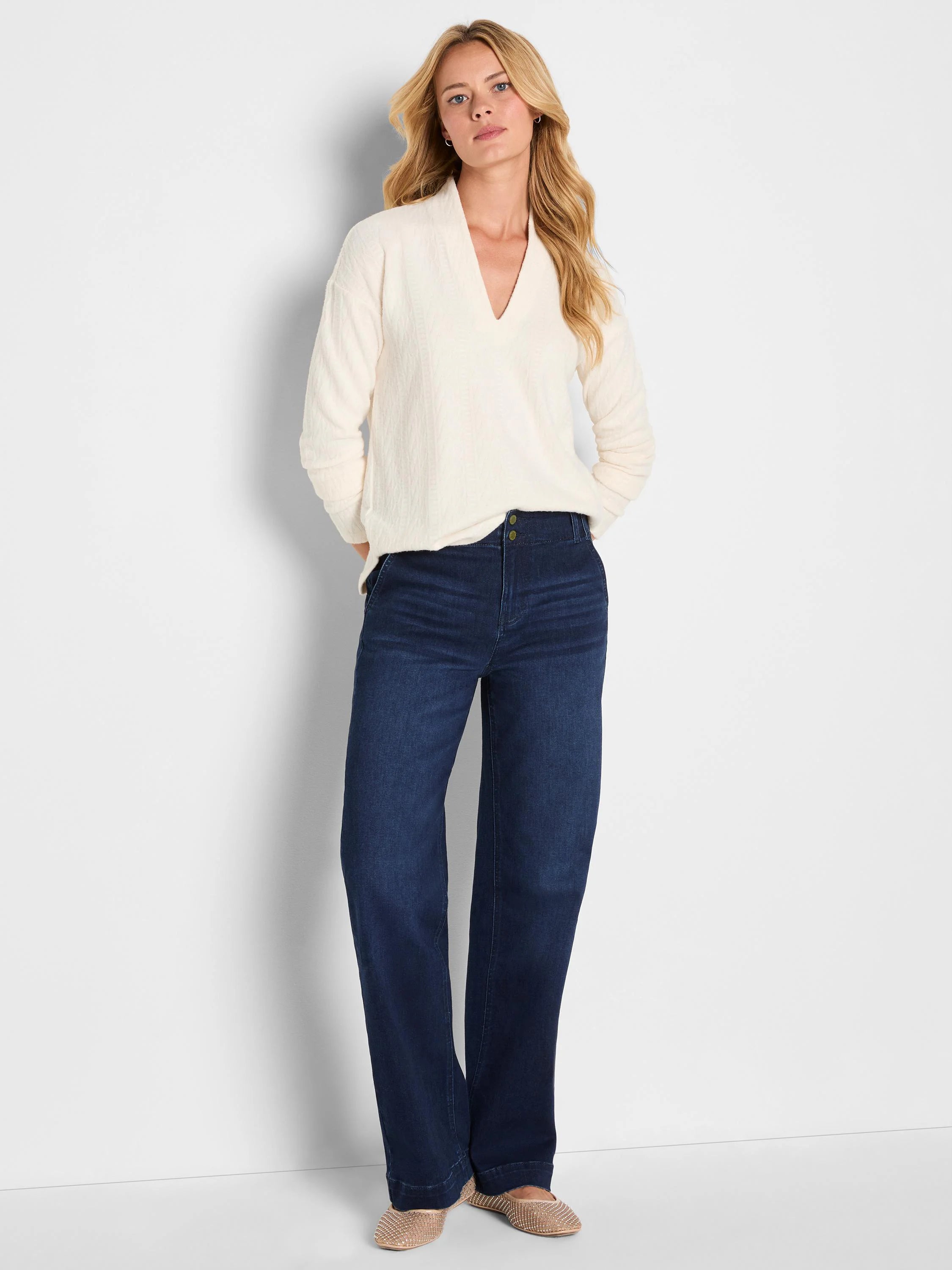 Cream cable knit V-neck top with long sleeves.