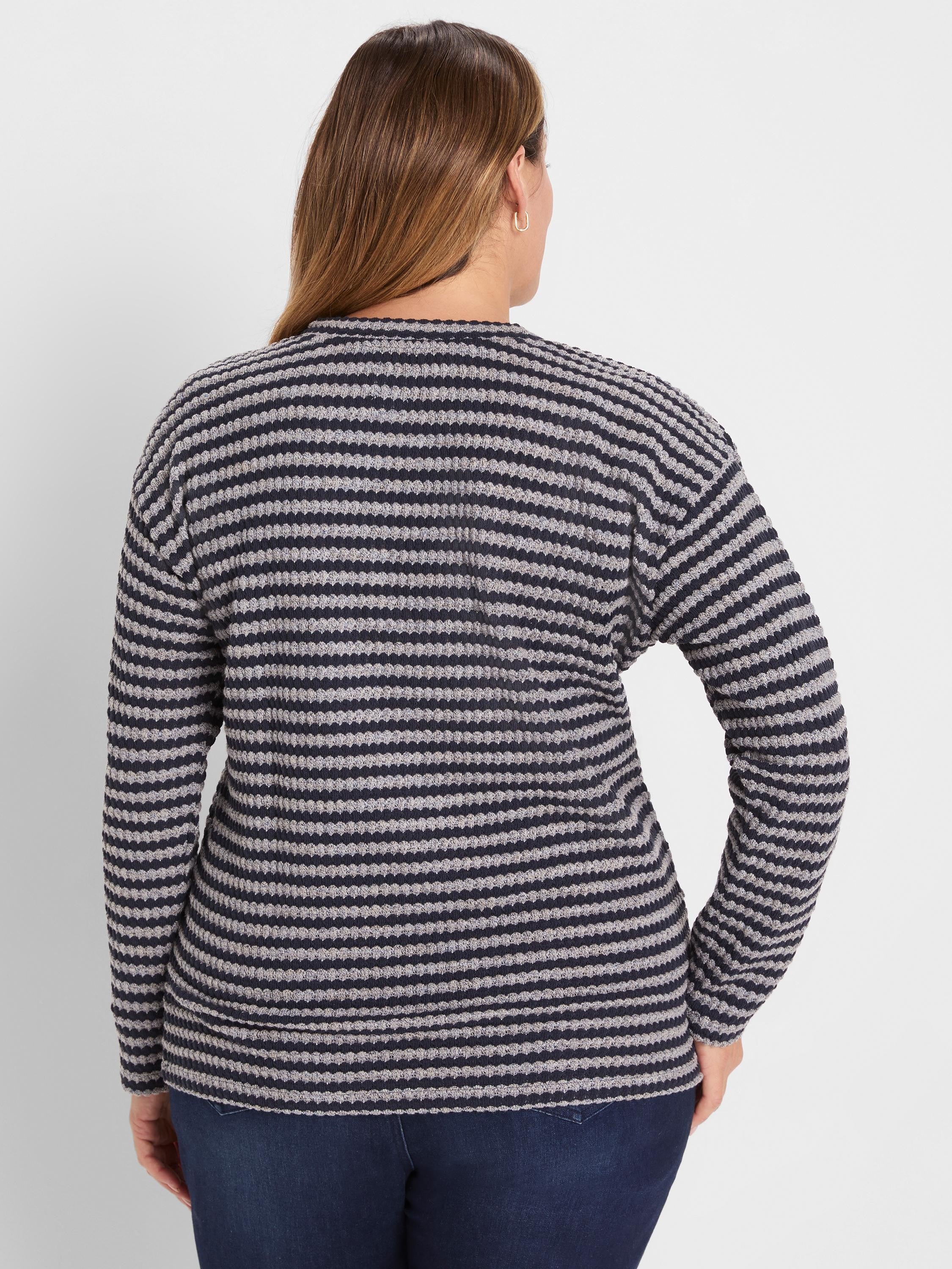Back view of a waffle-knit long-sleeve top with alternating dark blue and light gray horizontal stripes.