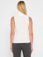Cream ribbed turtleneck tank top, sleeveless and fitted.
